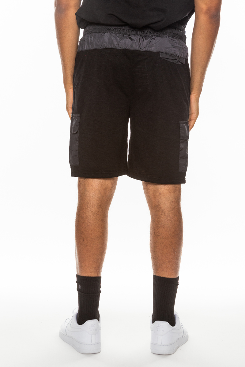 A pair of light weight slub shorts featuring a solid body, elastic waist with drawstring, and a single back pocket, made from 80% cotton and 20% spandex.