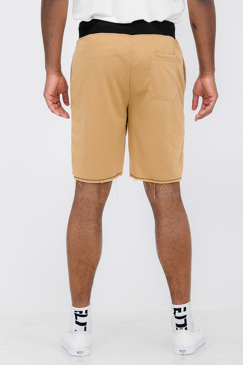 A pair of Raw Cut City Sweat Shorts in a stylish design, featuring an elastic waist with drawstring and a single back pocket.