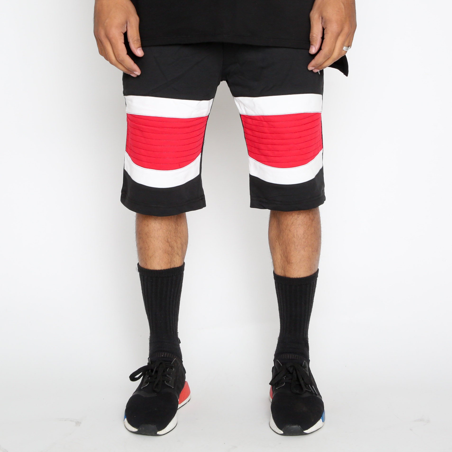 Red Stripe Moto Shorts featuring a white-red-white pattern and contrast zipper, designed for comfort and style with an elasticized waist and drawstring.