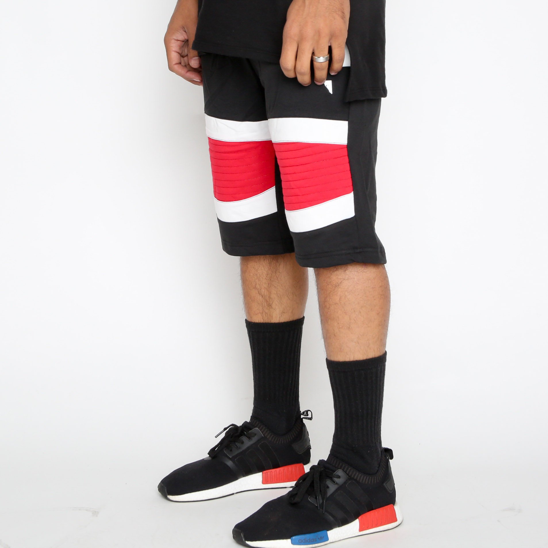 Red Stripe Moto Shorts featuring a white-red-white pattern and contrast zipper, designed for comfort and style with an elasticized waist and drawstring.