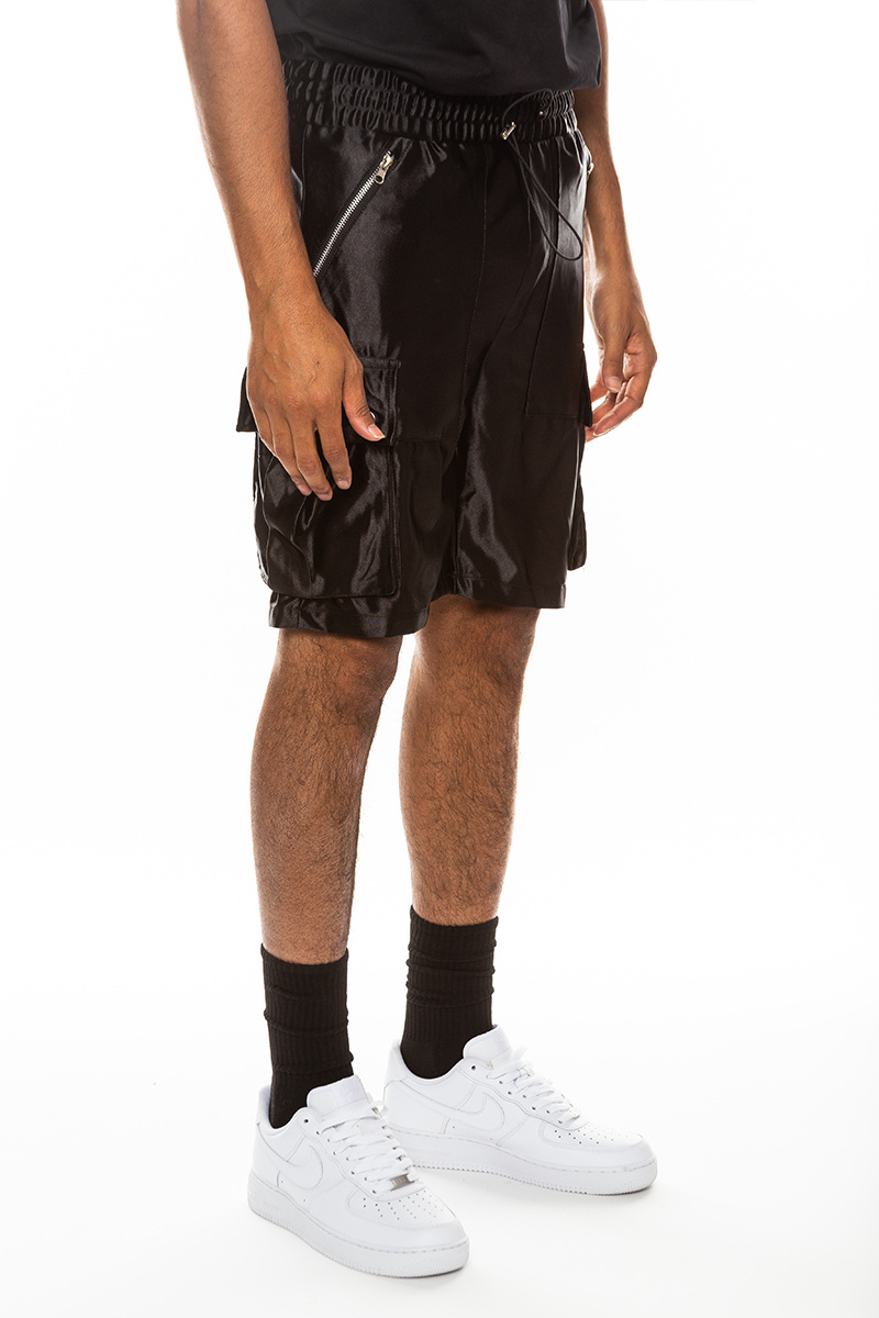 A pair of stylish satin cargo shorts featuring an elastic waist, drawstring, and multiple pockets in a sleek design.