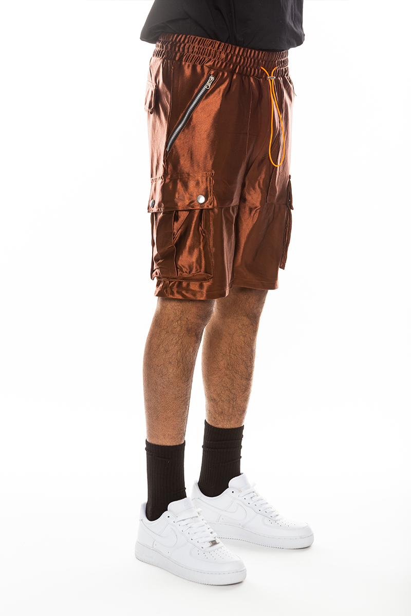 A pair of stylish satin cargo shorts featuring an elastic waist, drawstring, and multiple pockets in a sleek design.