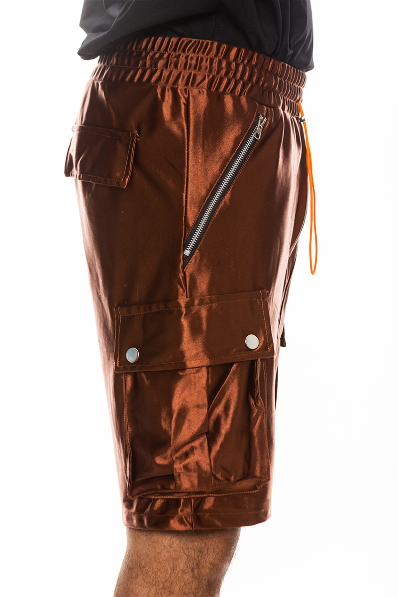 A pair of stylish satin cargo shorts featuring an elastic waist, drawstring, and multiple pockets in a sleek design.