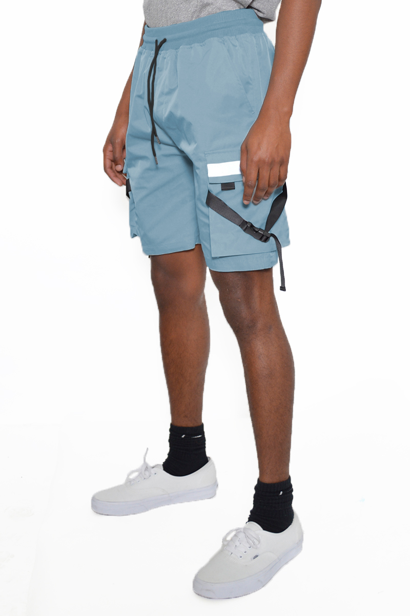 A pair of tactical cargo shorts featuring reflective tape, multiple cargo pockets, and an elastic waist with drawstring, ideal for outdoor activities.