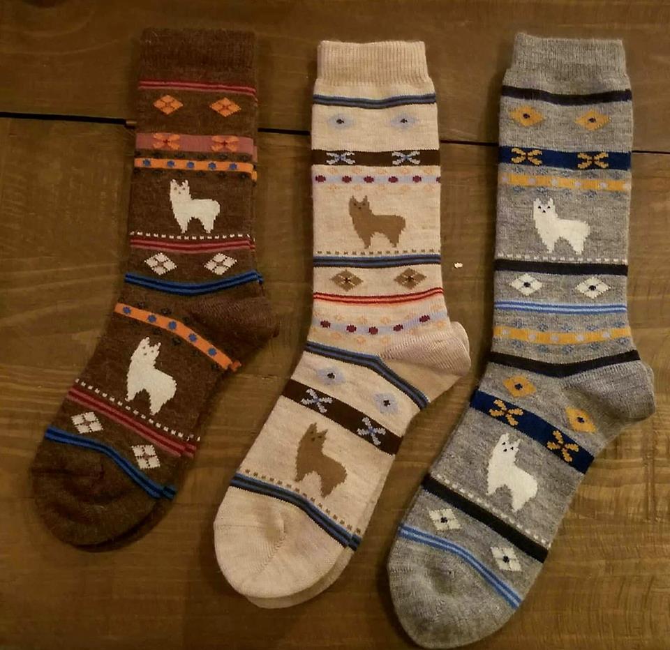 A pair of cozy alpaca watching socks featuring adorable alpaca designs, available in brown, beige, and grey colors, suitable for both adults and children.