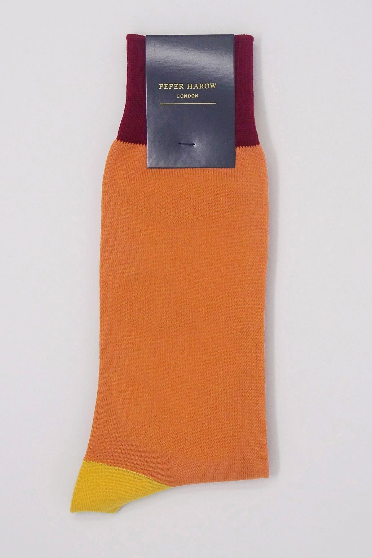 Burgess Men's Socks in vibrant orange with yellow heel and burgundy cuff, showcasing luxury and style.