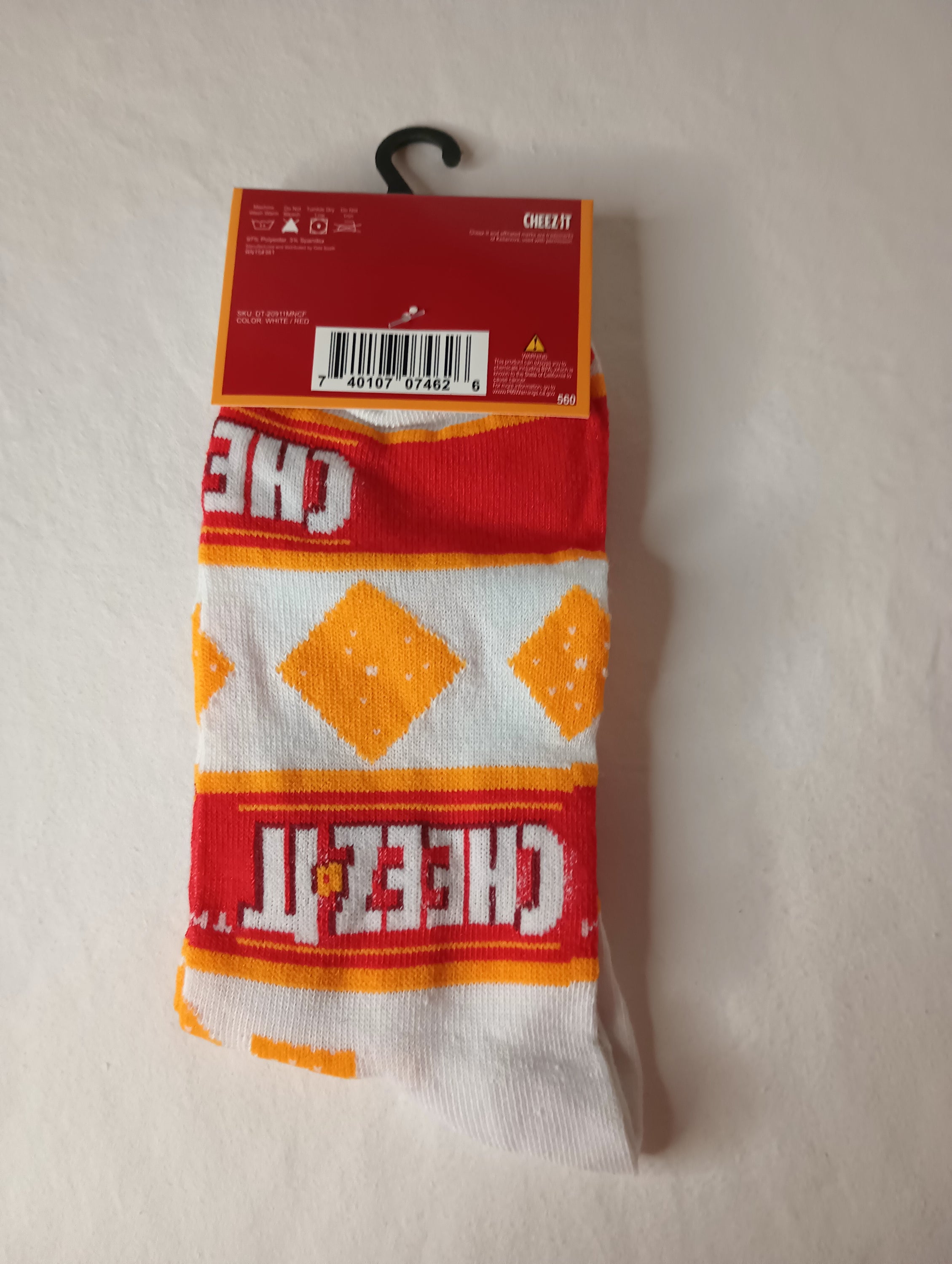 A pair of vibrant CHEEZ-IT Crew Socks in orange, white, and red colors, designed for men's shoe sizes 6-12.