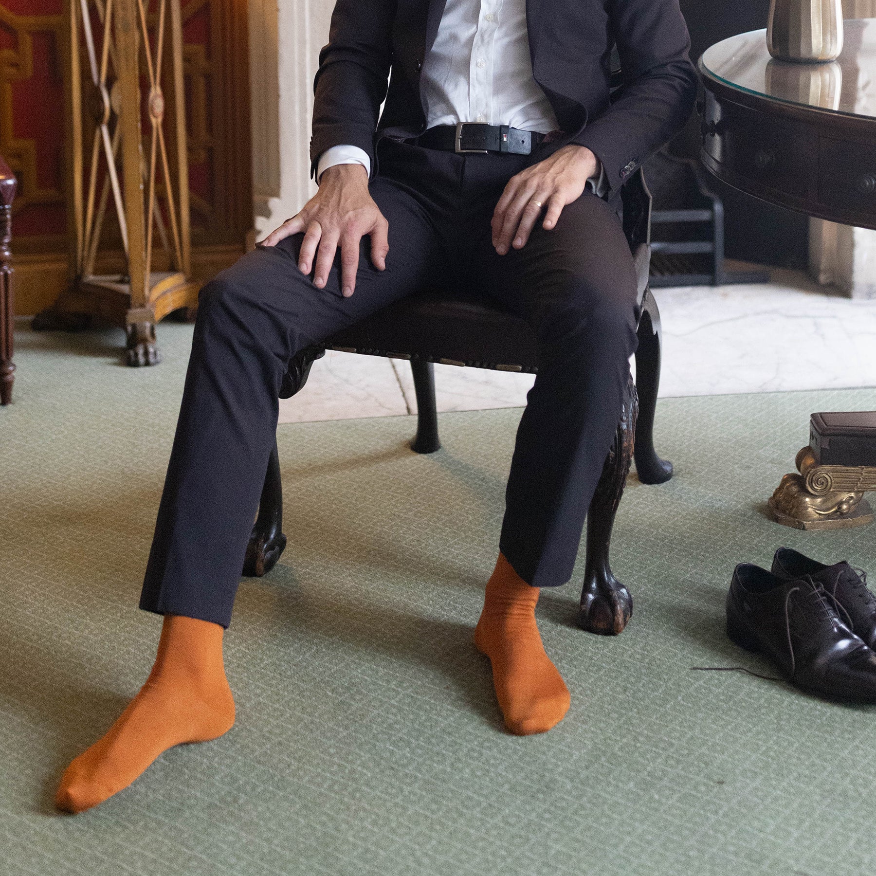 A pair of classic men's socks in burnt orange, made from Mercerised Egyptian cotton, showcasing a seamless toe design.