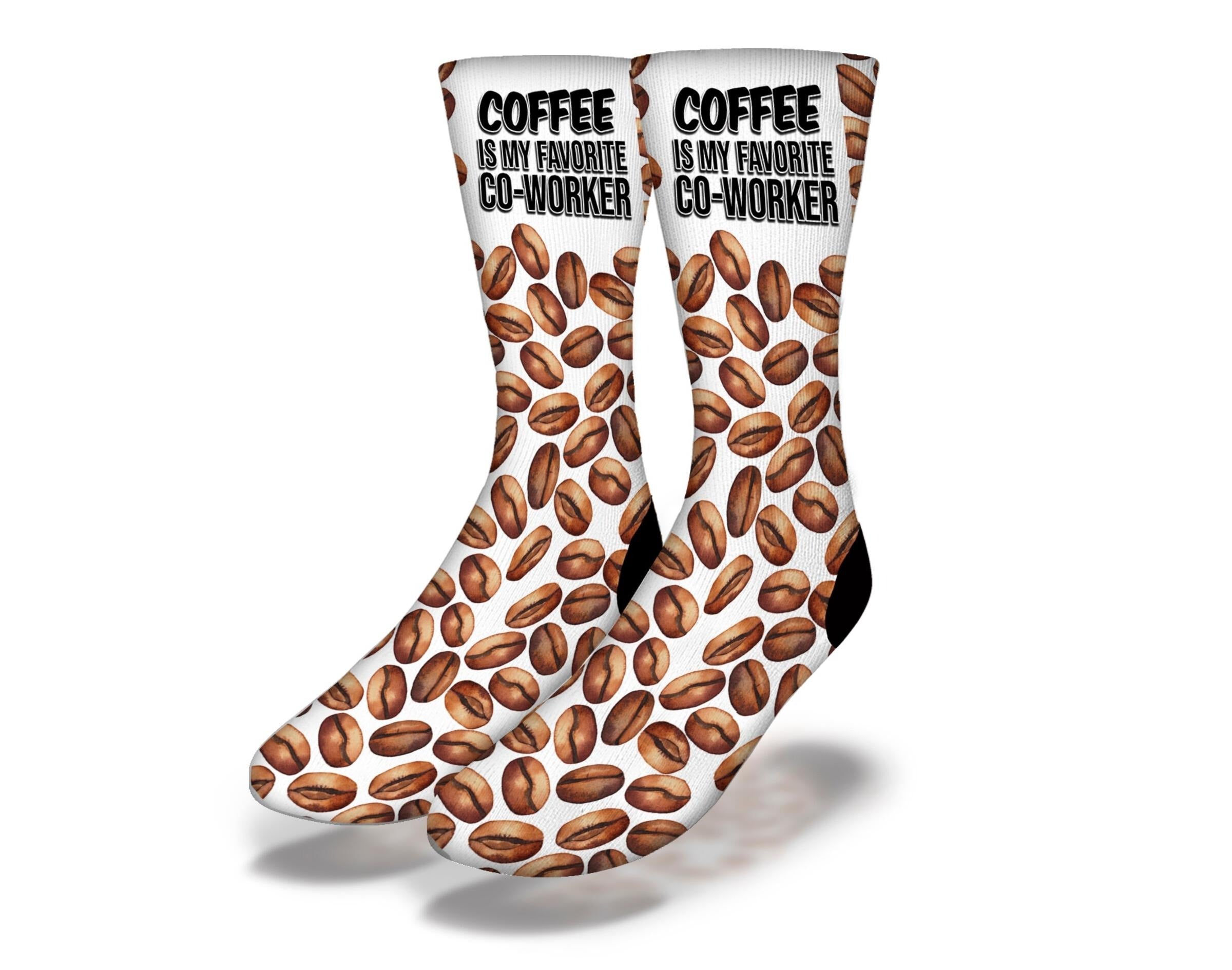 A pair of white Coffee CoWorker Socks displayed on a wooden surface, showcasing their soft fabric and stylish design.