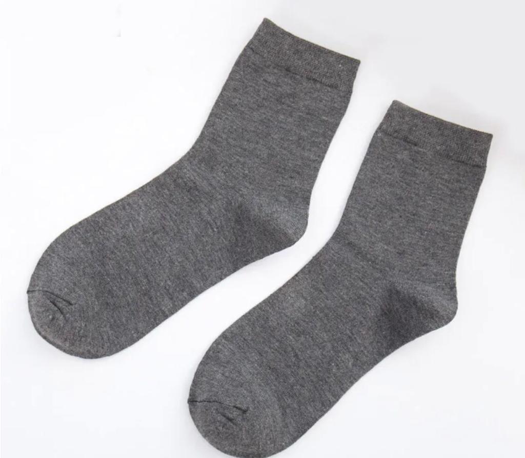 A pack of GK Cotton Blend Men's Dress Socks in black, gray, and blue, showcasing their comfortable and stylish design.