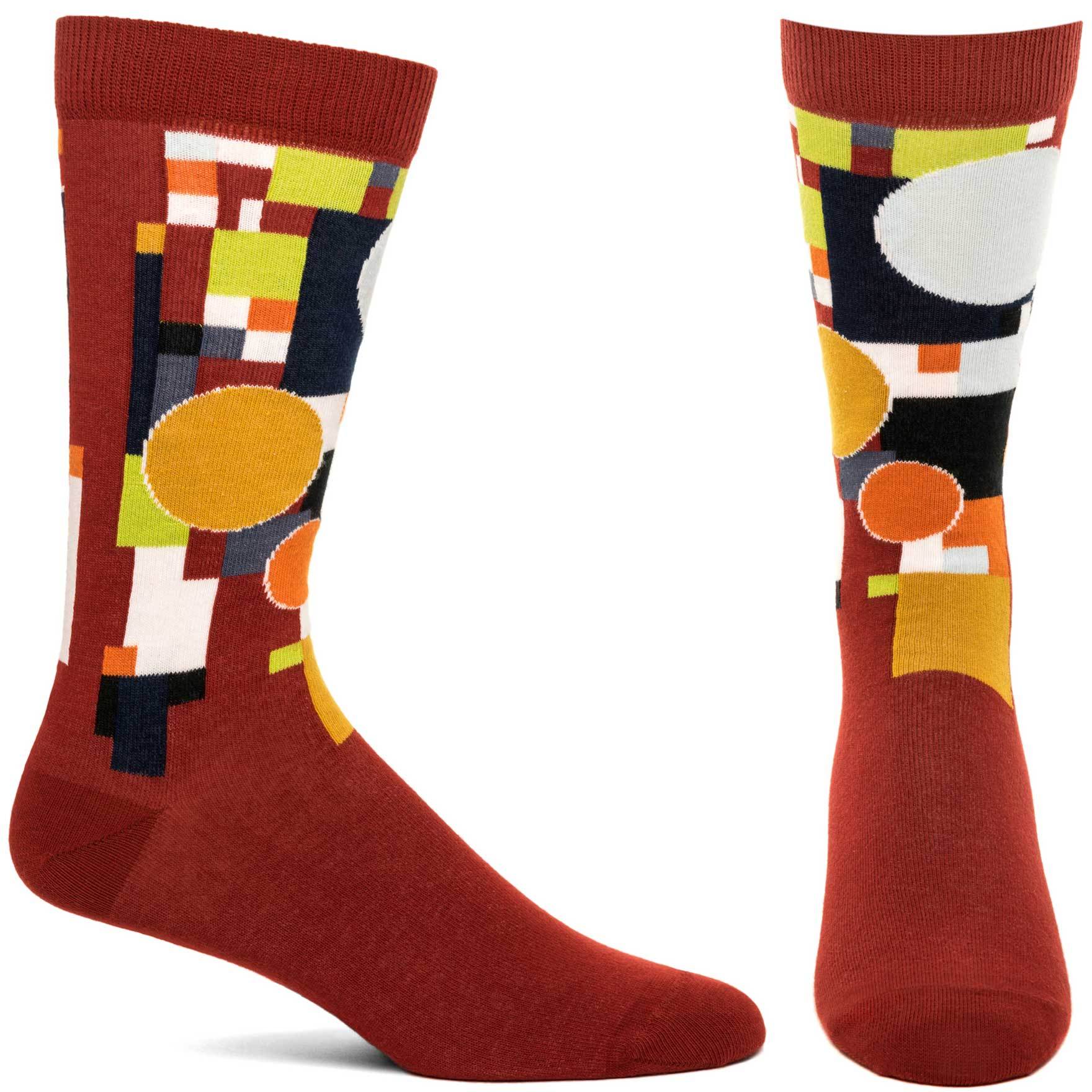 A pair of FLW Coonley Playhouse socks featuring vibrant abstract stained glass designs inspired by Frank Lloyd Wright's architecture.