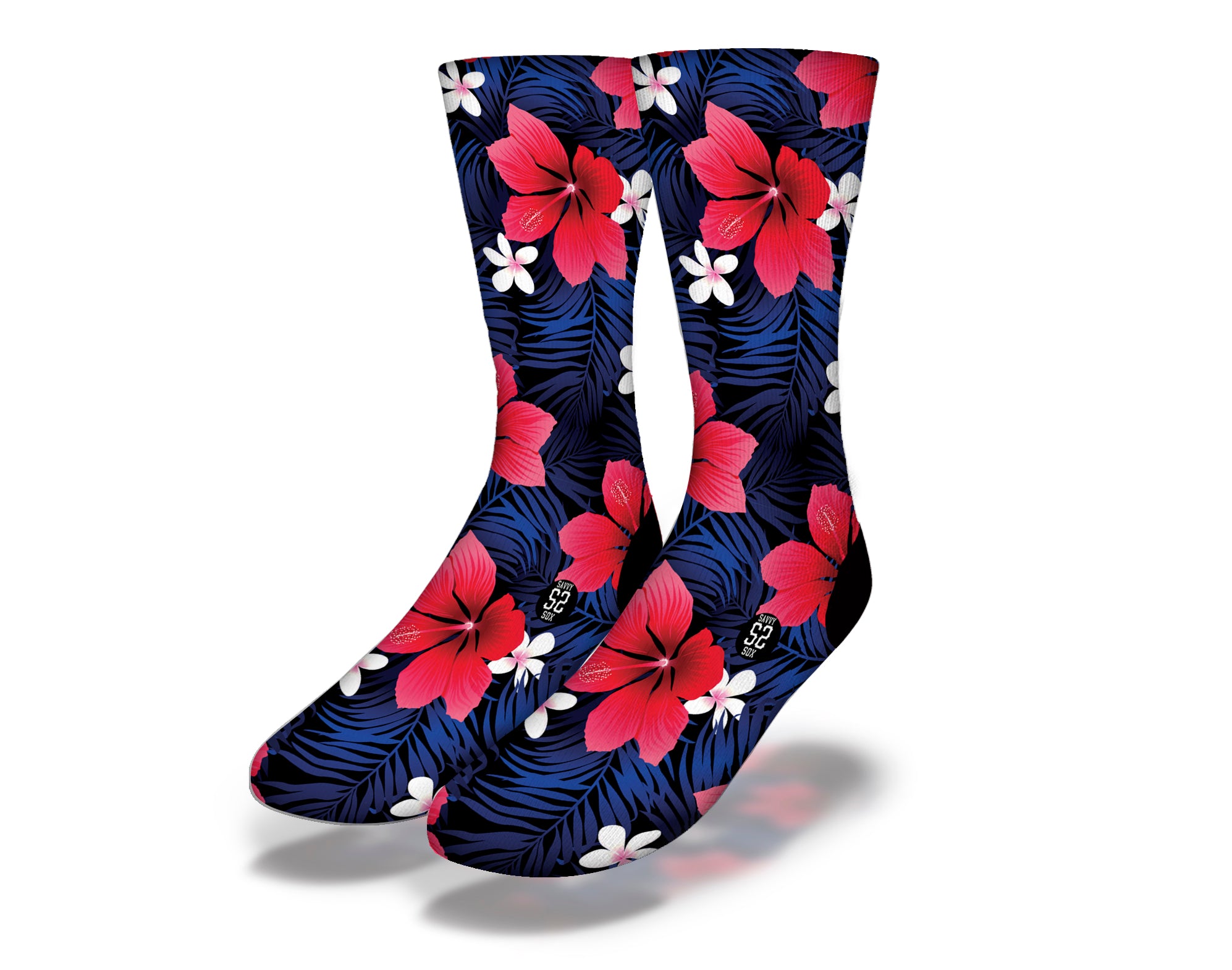 A pair of vibrant hot pink Hawaiian hibiscus flower socks against a deep blue palm frond background, showcasing a tropical design.