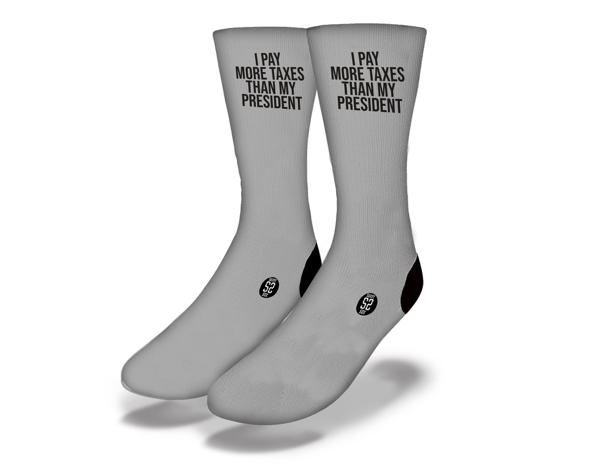 Gray socks with the phrase 'I Pay More Taxes' printed on them, showcasing a humorous tax-themed design.