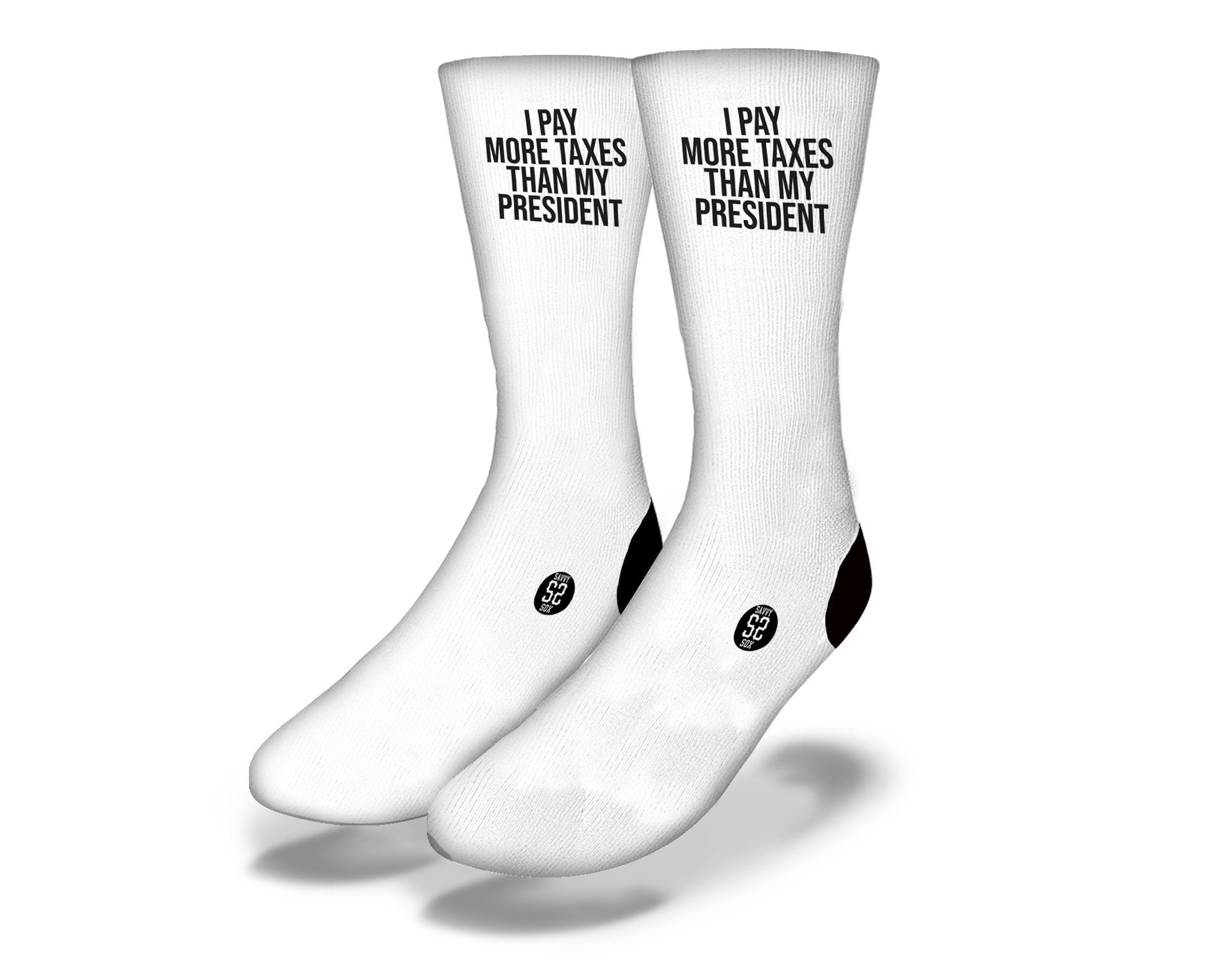 White socks with bold black text saying 'I Pay More Taxes', showcasing a humorous design perfect for tax season.