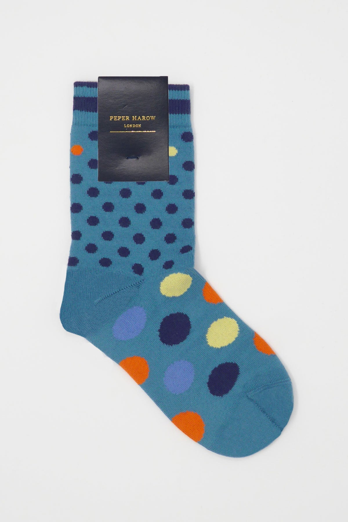 Colorful Mary Women's Socks featuring a peacock polka dot design in yellow, orange, navy, and blue, made from luxurious Supima cotton.