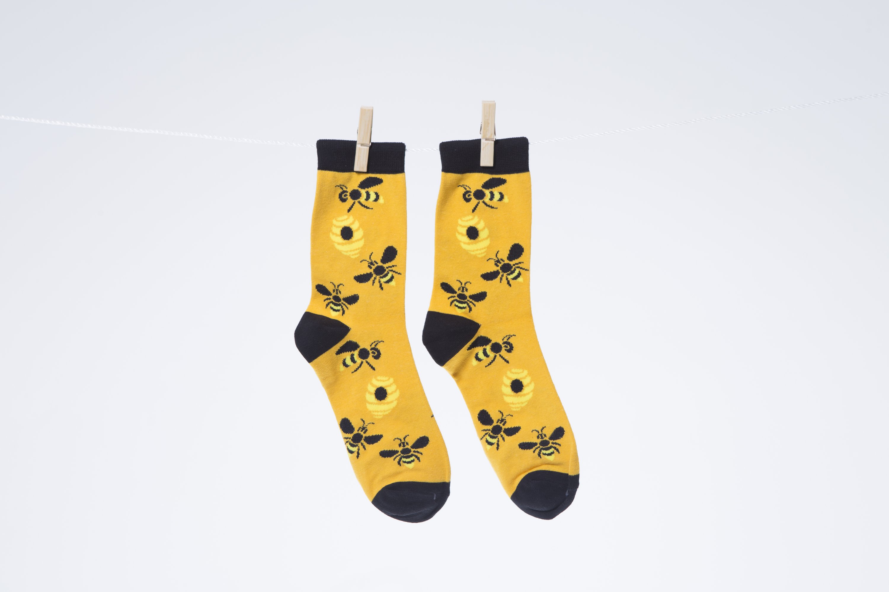 A pair of stylish Men's Bees Socks made from premium combed cotton, featuring a playful bee design.