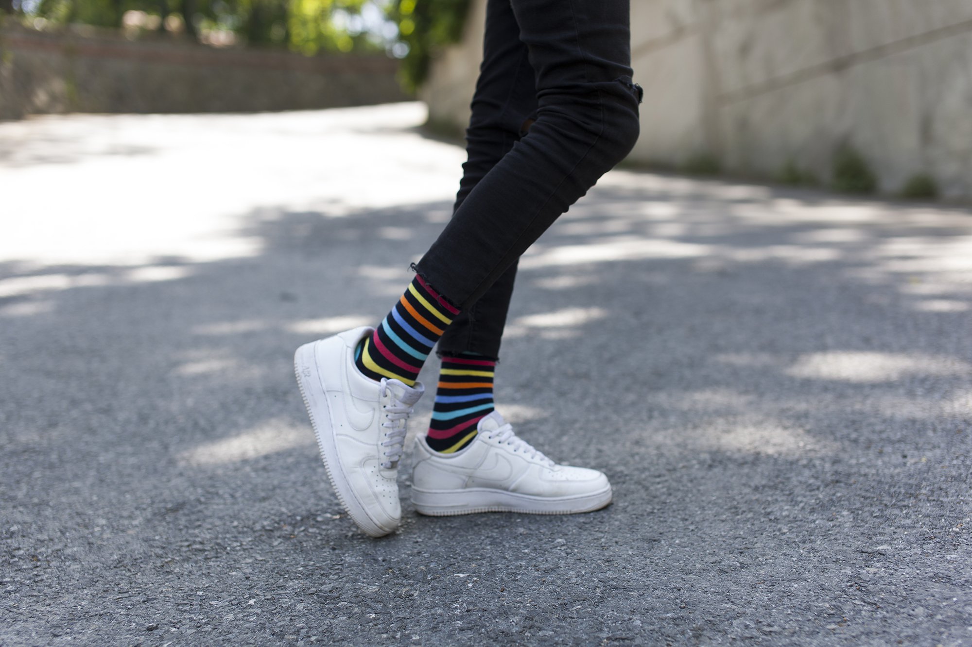 Men's Black Rainbow Stripe Socks featuring vibrant colors and a stylish design, perfect for adding flair to any outfit.