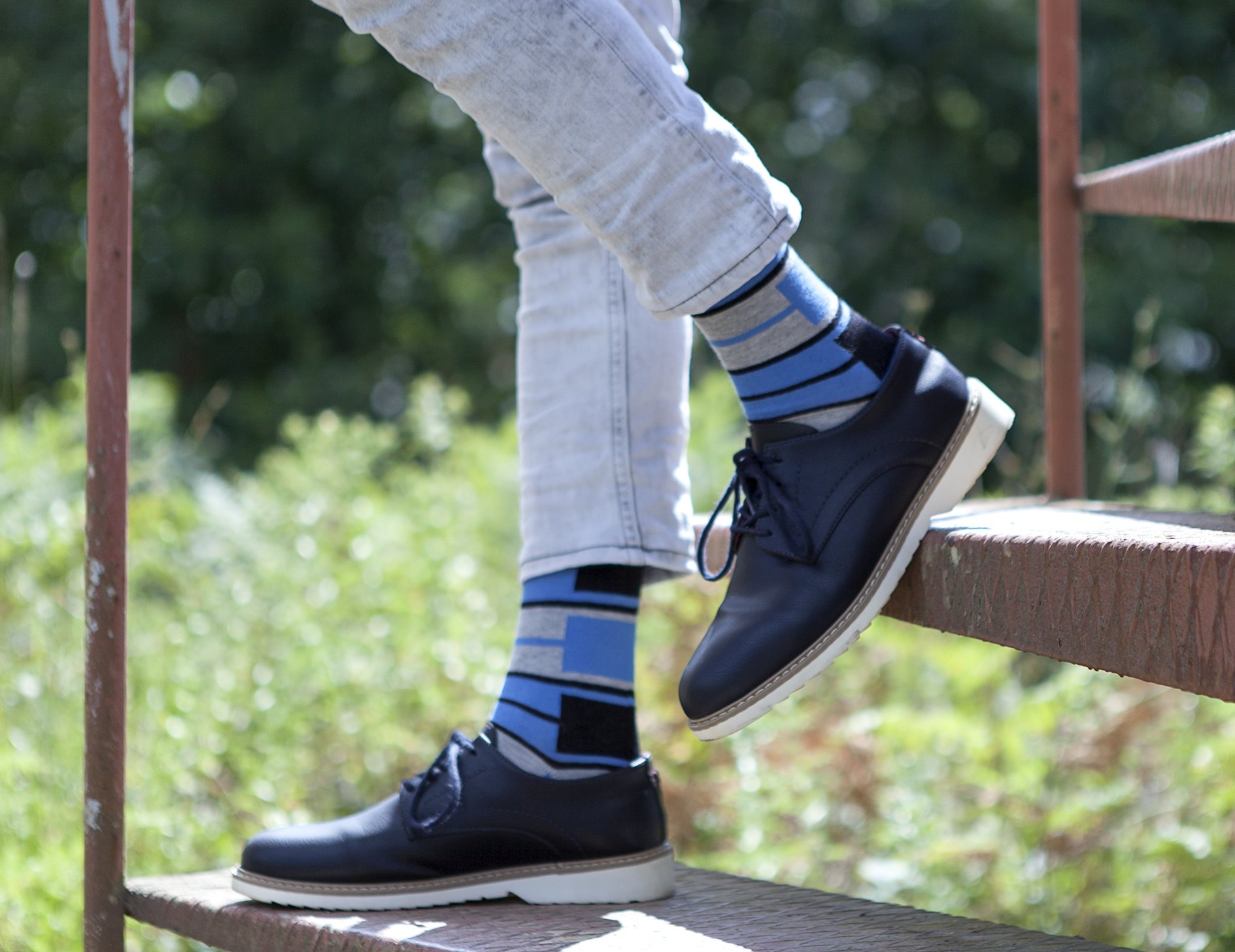 Men's blue patterned socks featuring vibrant designs and soft cotton material, perfect for stylish comfort.