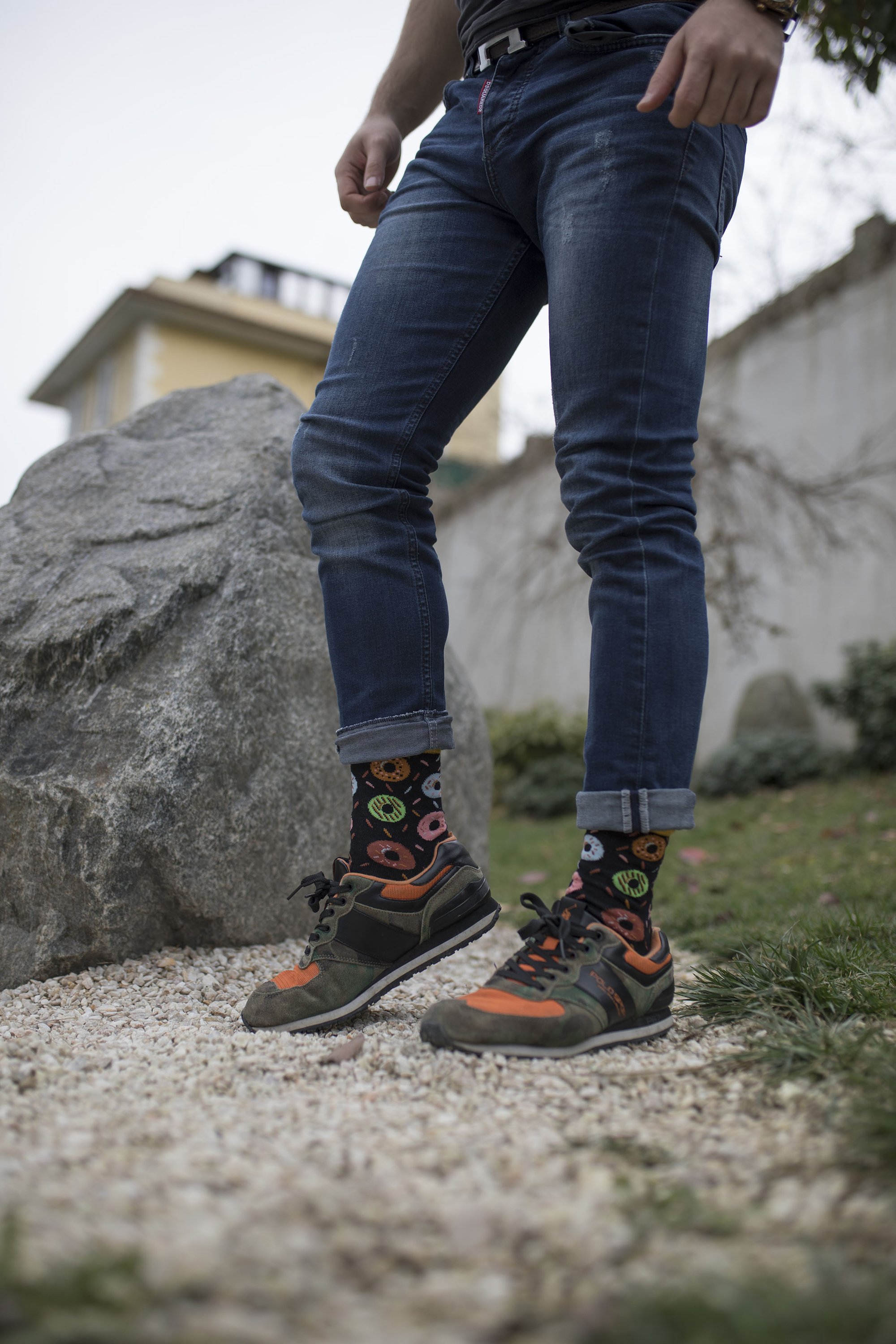 A pair of colorful men's socks featuring a playful donut pattern, made from soft combed cotton.