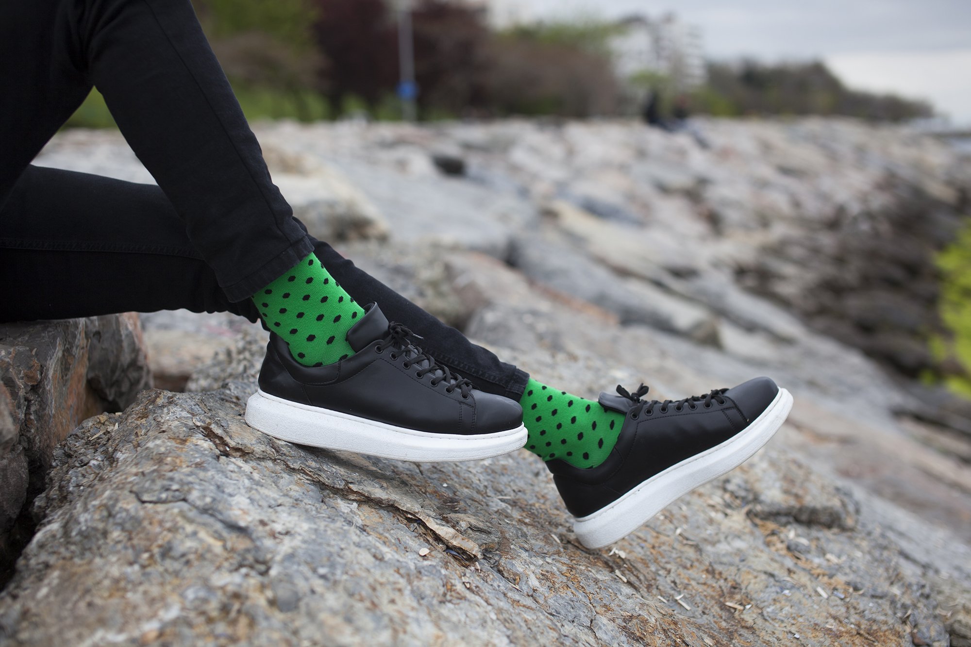 Green polka dot socks outdoors.