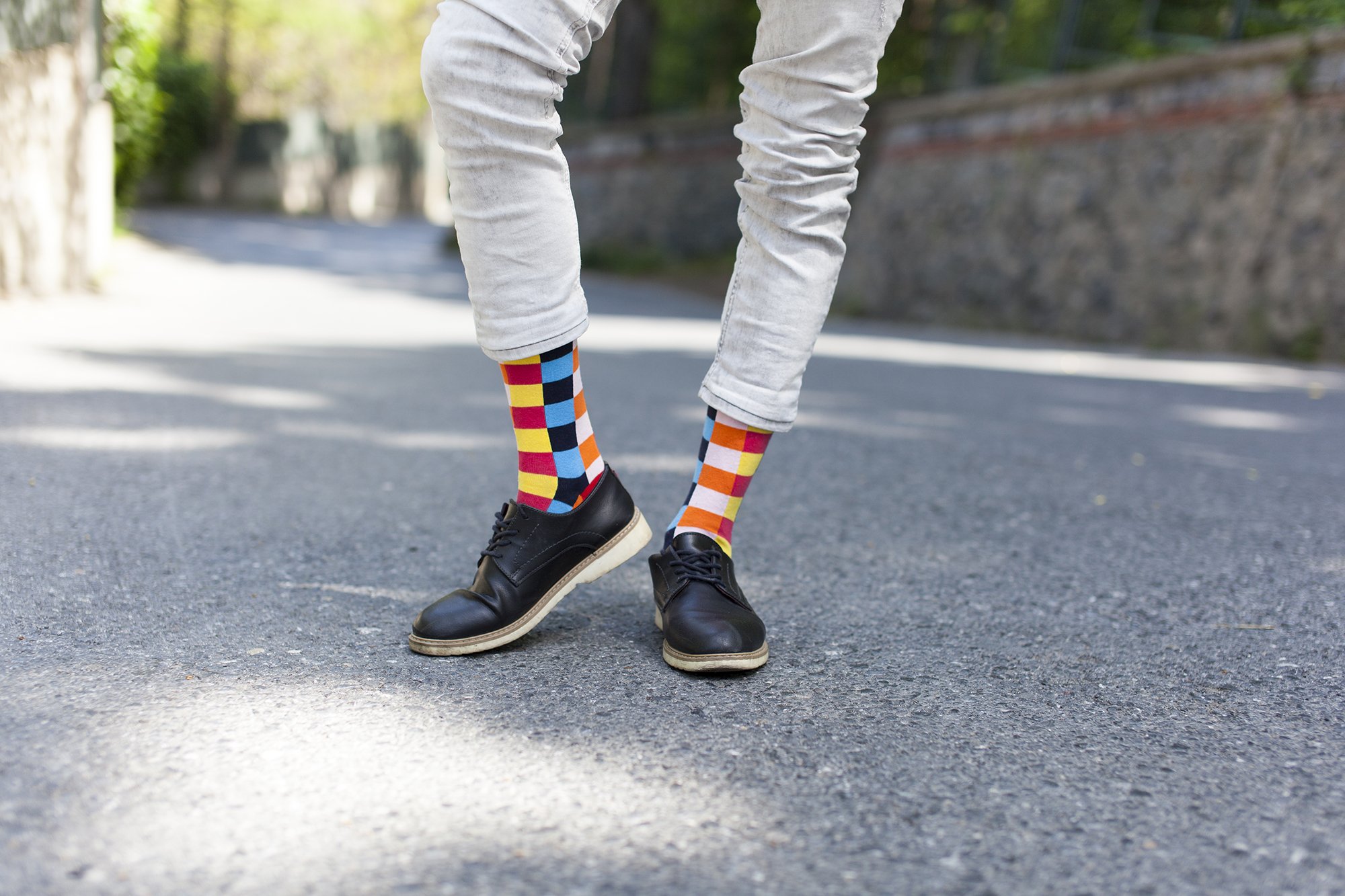 A collection of colorful men's dress socks featuring trendy patterns and designs, perfect for adding style to any outfit.