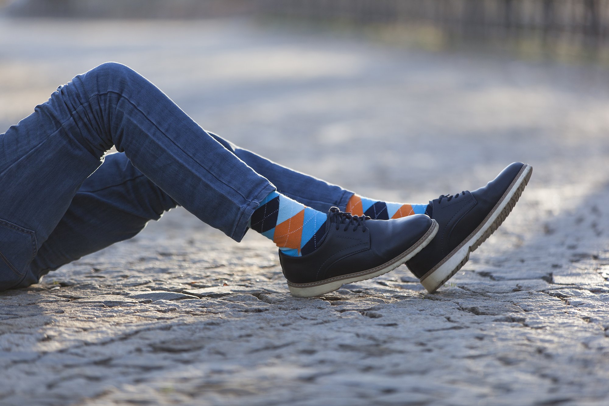 A collection of colorful men's dress socks featuring trendy patterns and designs, perfect for adding style to any outfit.