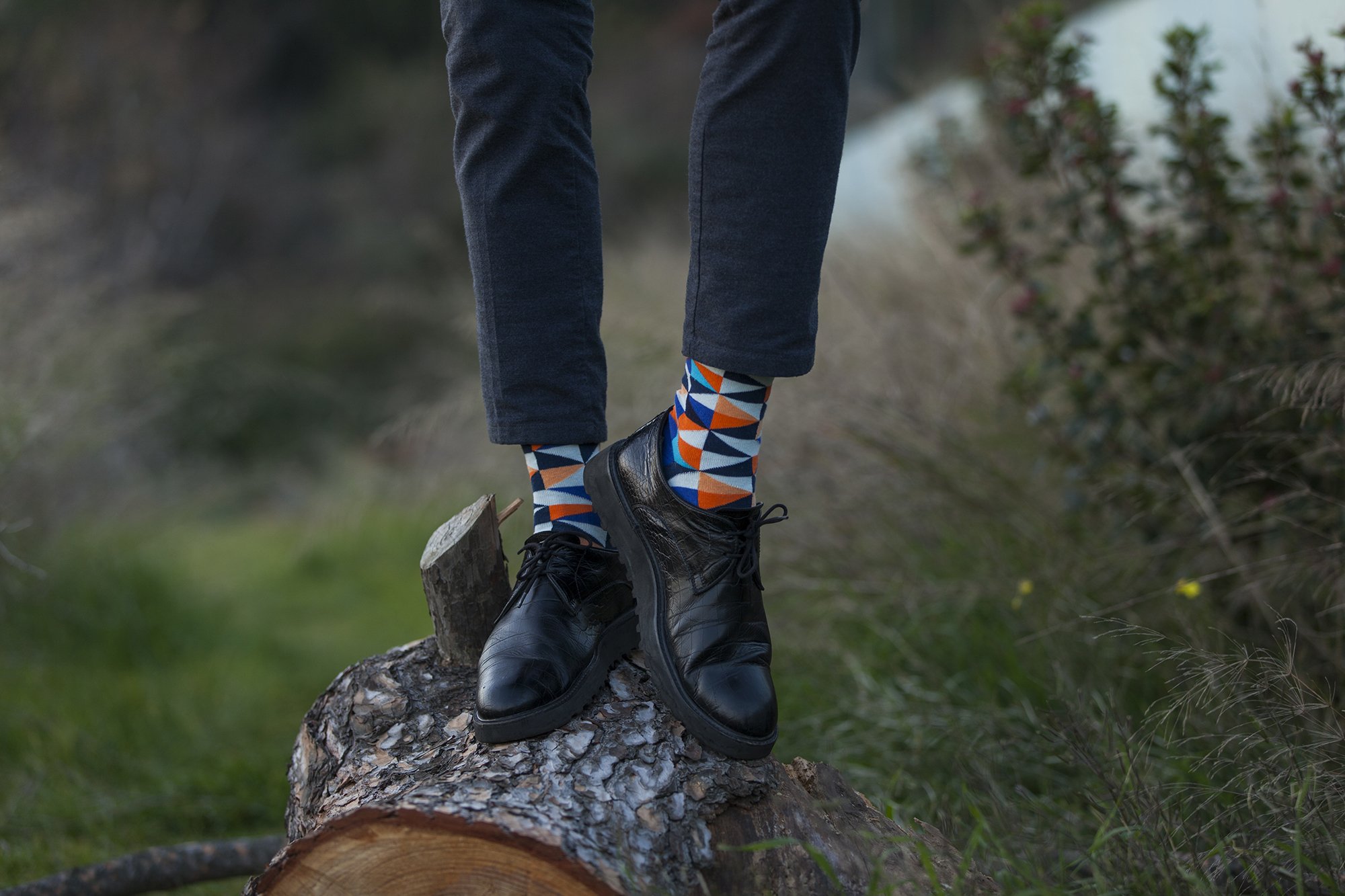 A collection of colorful men's dress socks featuring trendy patterns and designs, perfect for adding style to any outfit.