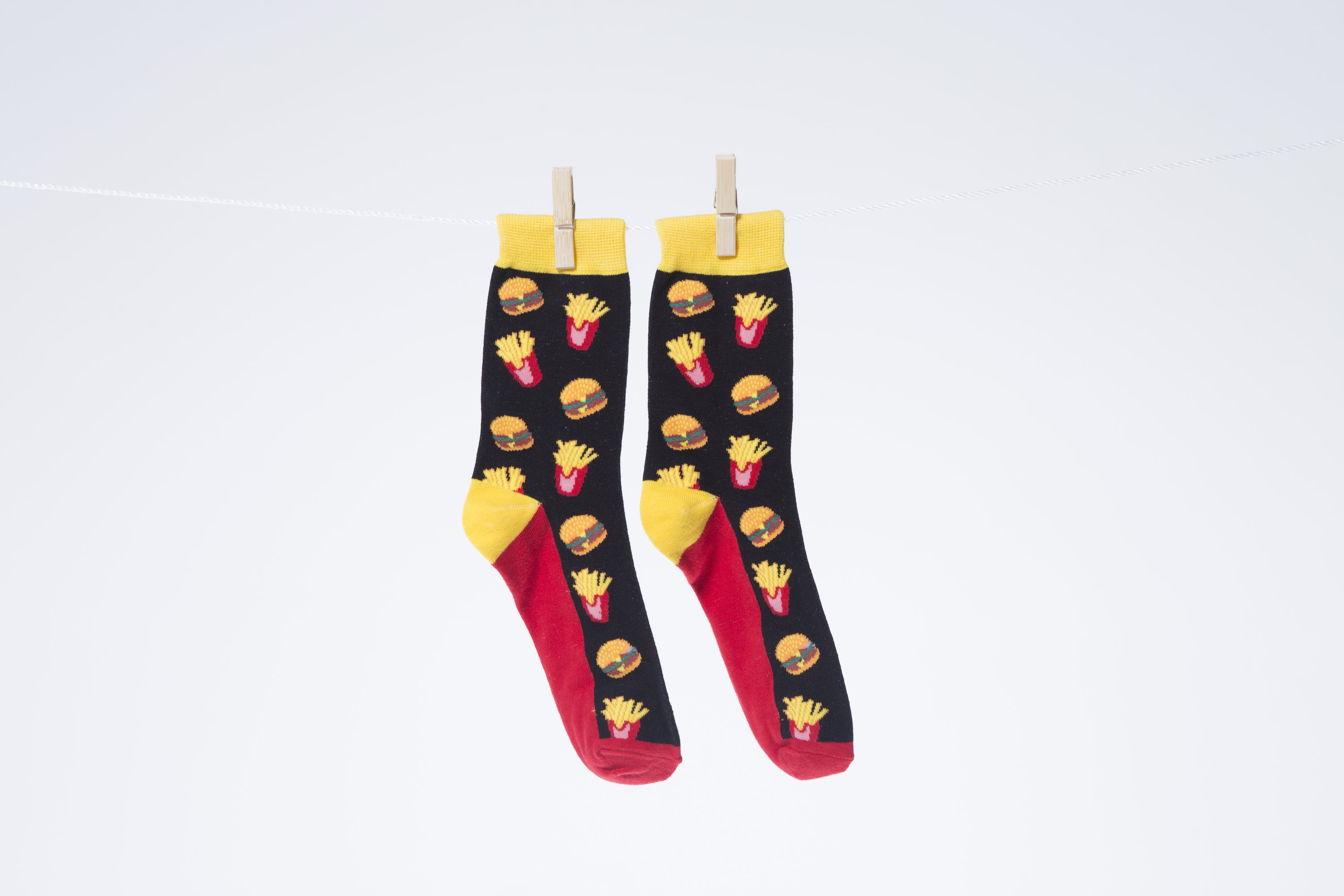 A pair of stylish Men's Fries Socks featuring a fun fries design, made from soft combed cotton for comfort.