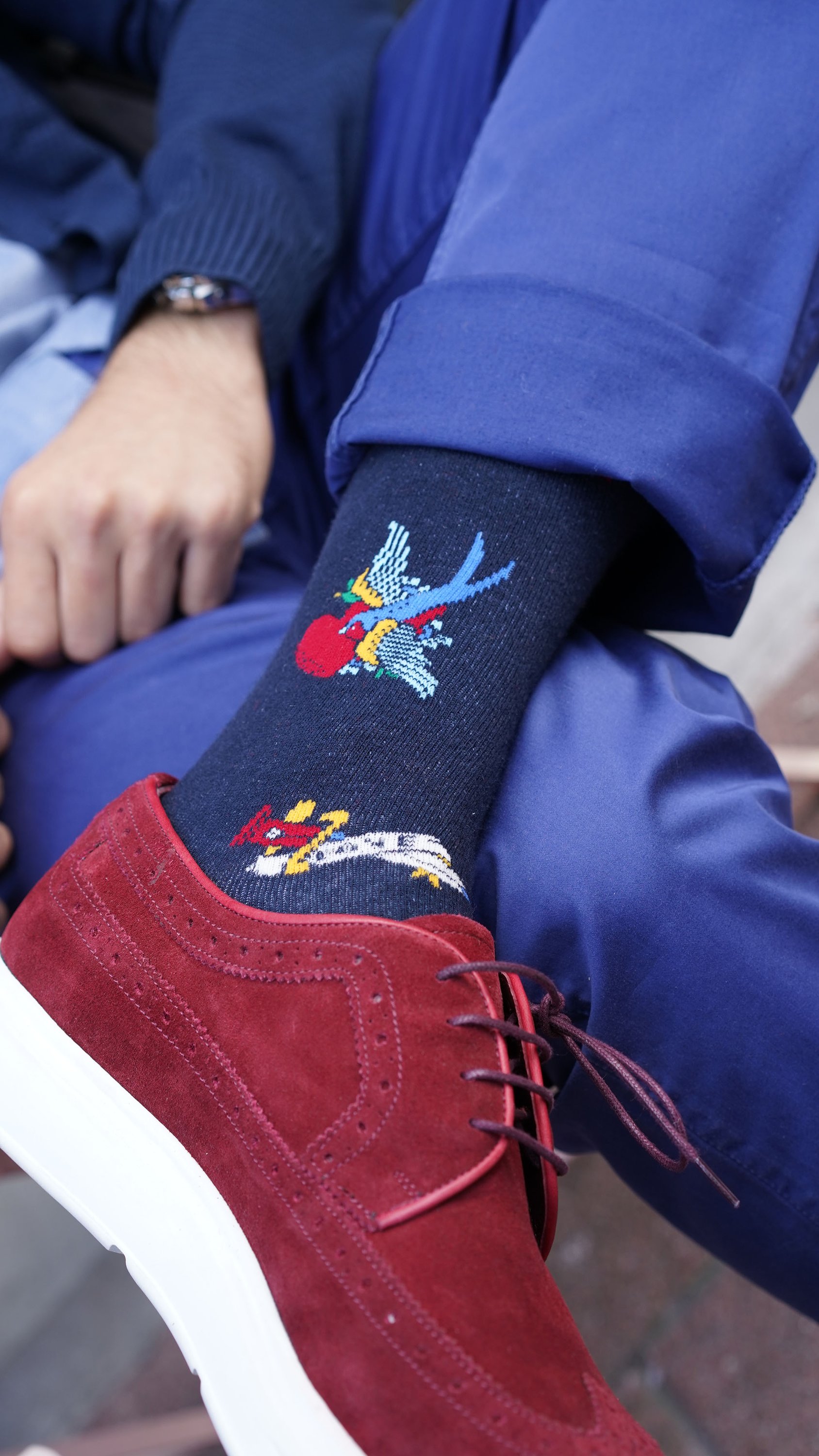 A collection of colorful men's funky socks featuring various trendy patterns and designs, perfect for adding style to any outfit.