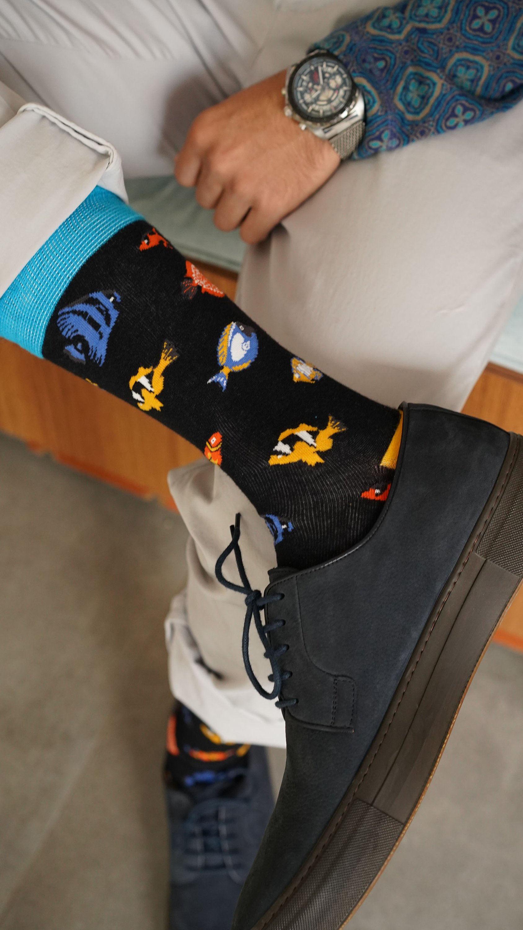 A collection of colorful men's funky socks featuring various trendy patterns and designs, perfect for adding style to any outfit.