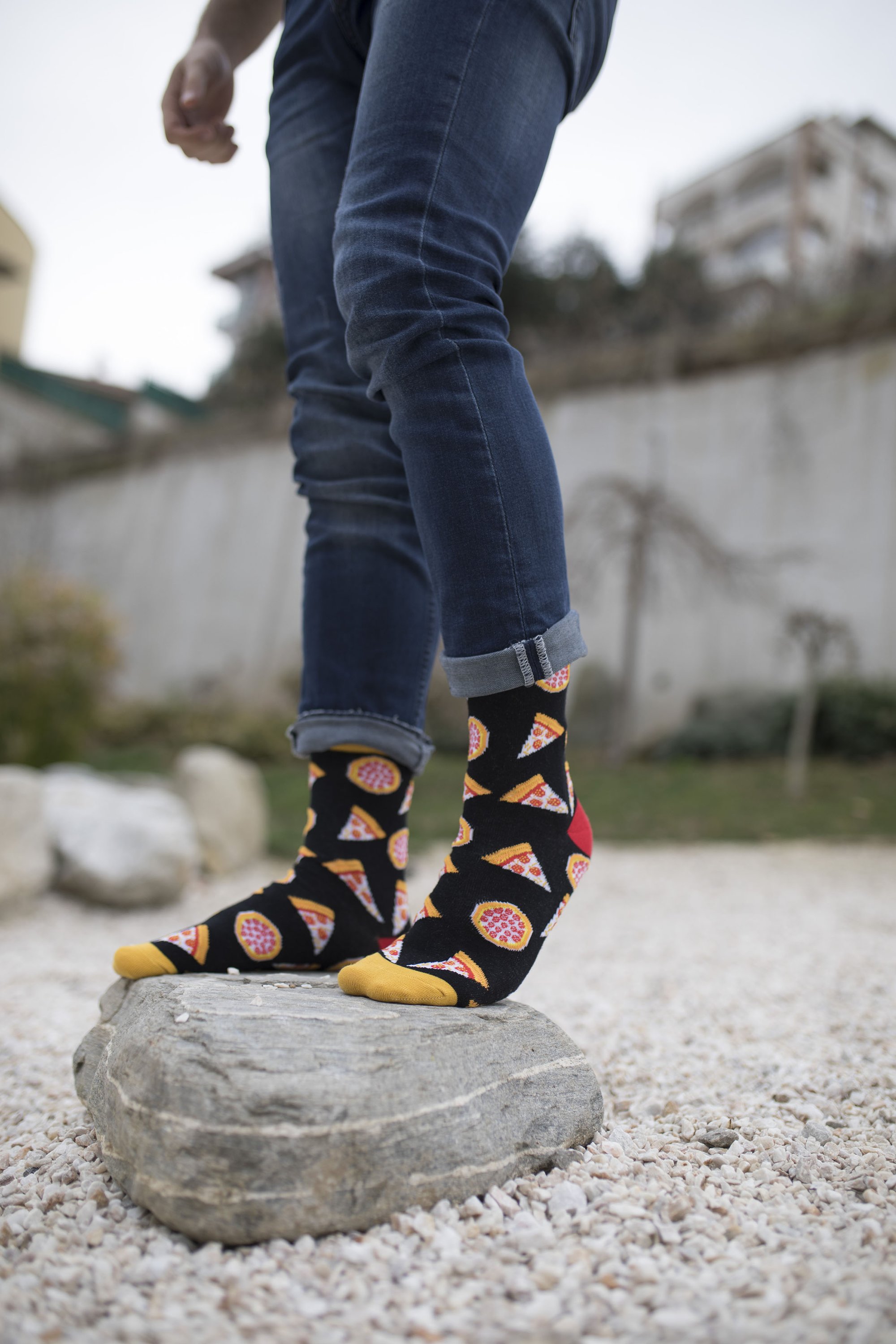 A pair of colorful men's socks featuring a fun pizza design, made from soft combed cotton.