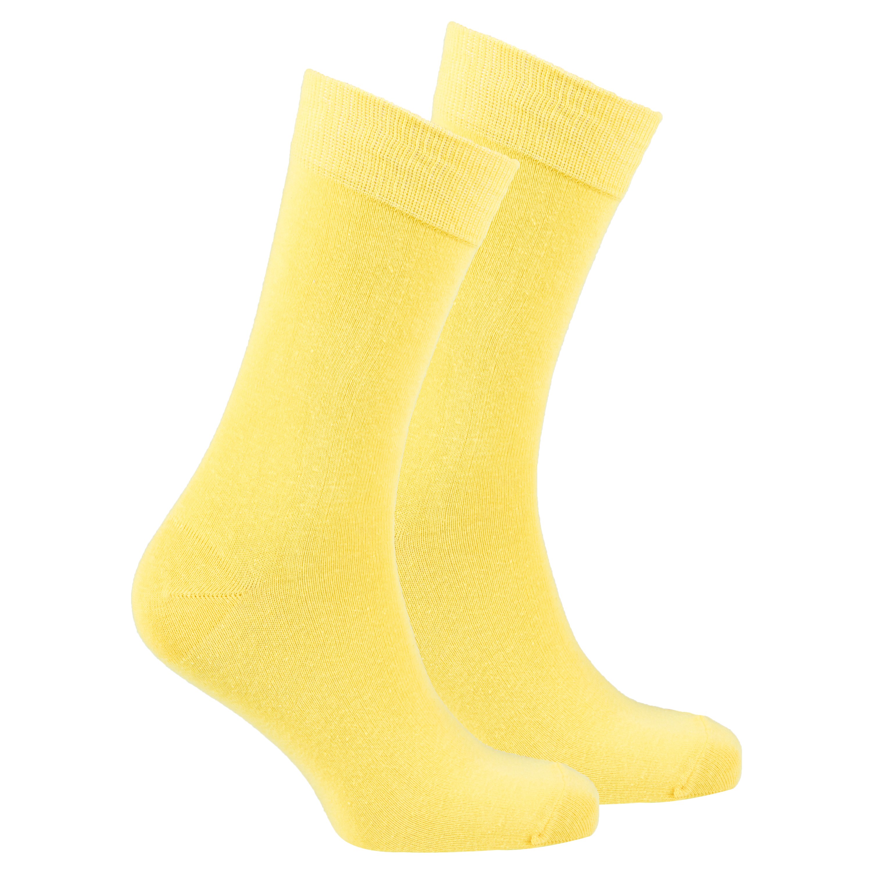 A pair of vibrant men's solid yellow socks made from soft Turkish cotton, showcasing a trendy and stylish design.