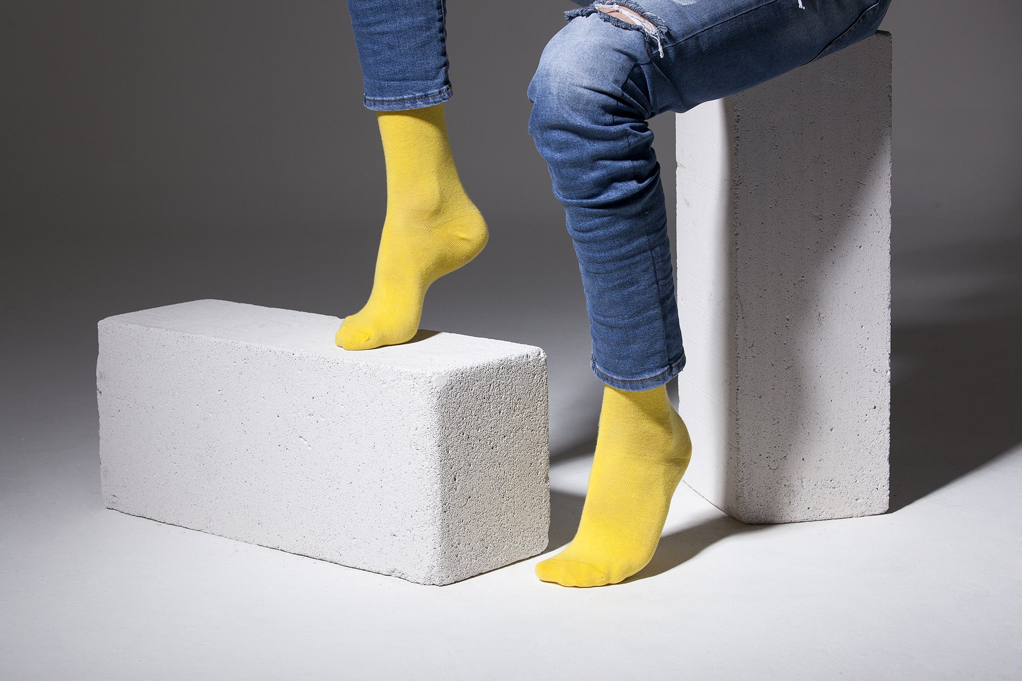 A pair of vibrant men's solid yellow socks made from soft Turkish cotton, showcasing a trendy and stylish design.