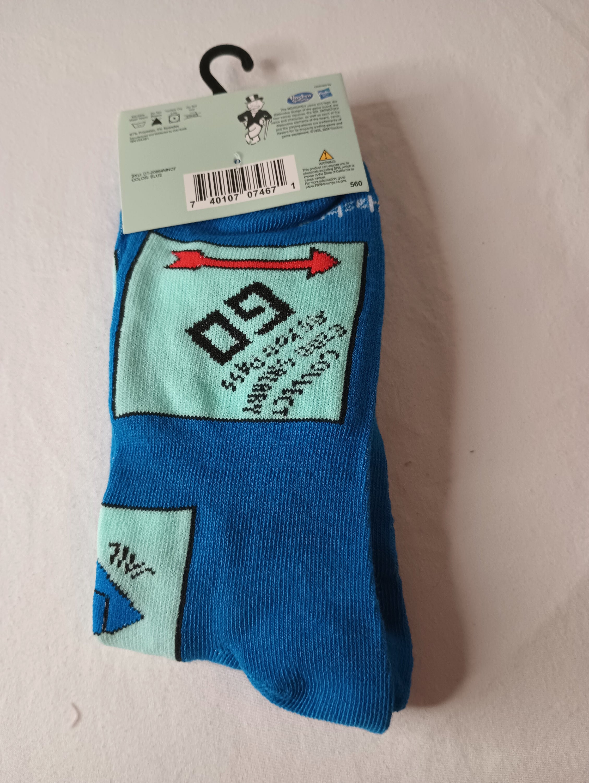 A pair of blue multi-color MONOPOLY Crew Socks designed for men, featuring a playful design inspired by the classic board game.