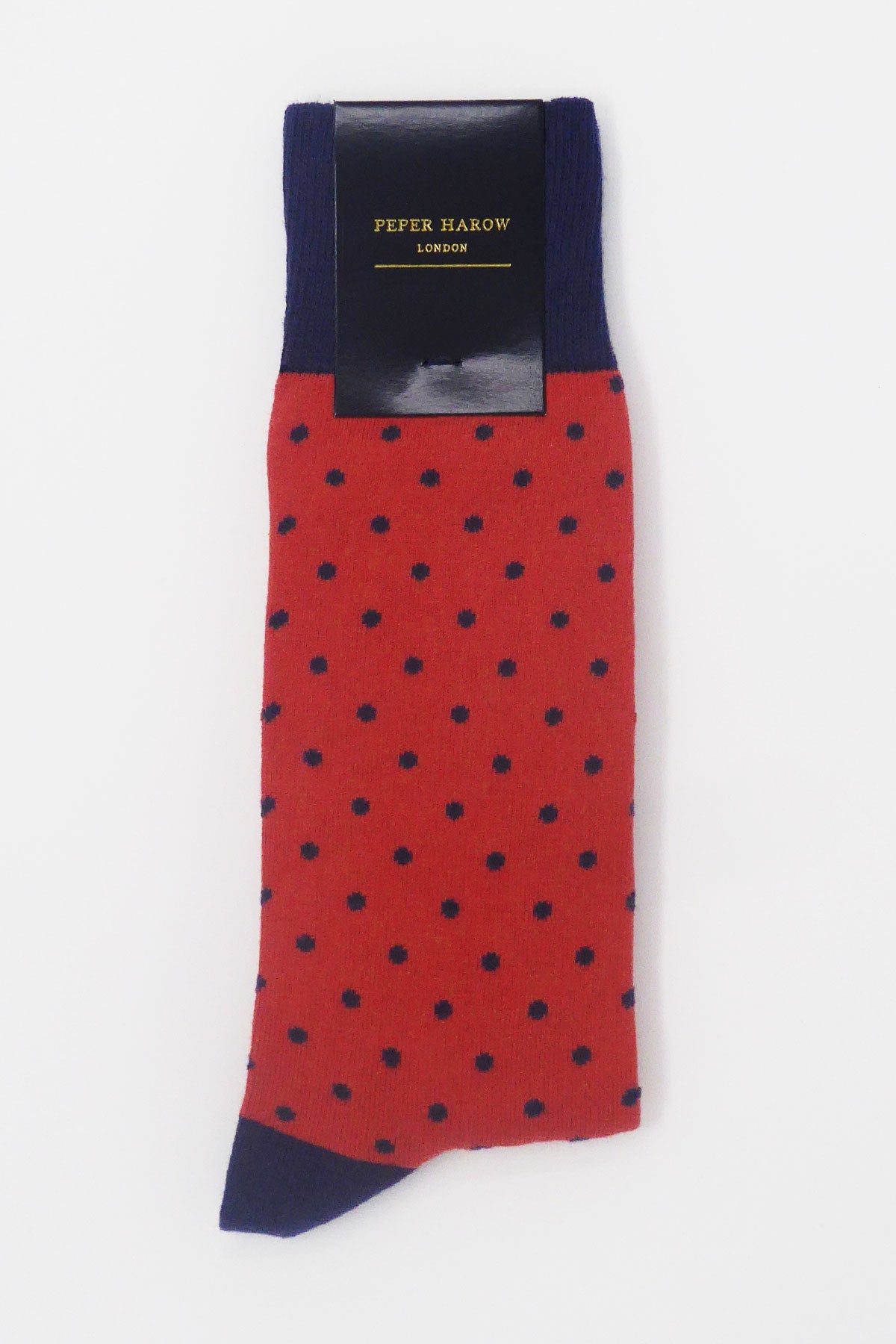 A pair of vibrant apple-colored men's socks with polka dots, featuring contrasting cuffs, heels, and toes, made from luxurious Supima cotton.