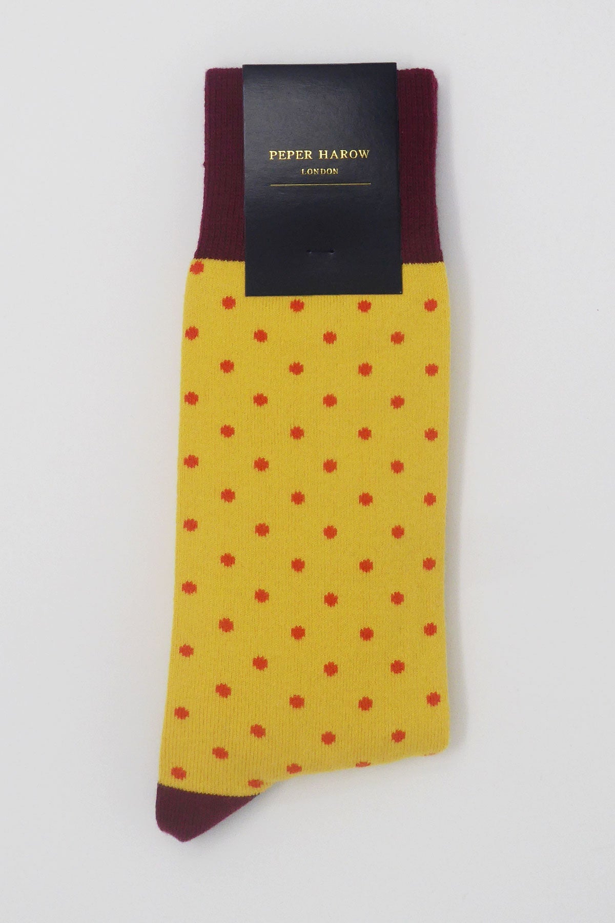 Pin Polka Men's Socks in Honey featuring vibrant polka dots and contrasting cuffs, heels, and toes, made from luxurious Supima cotton.