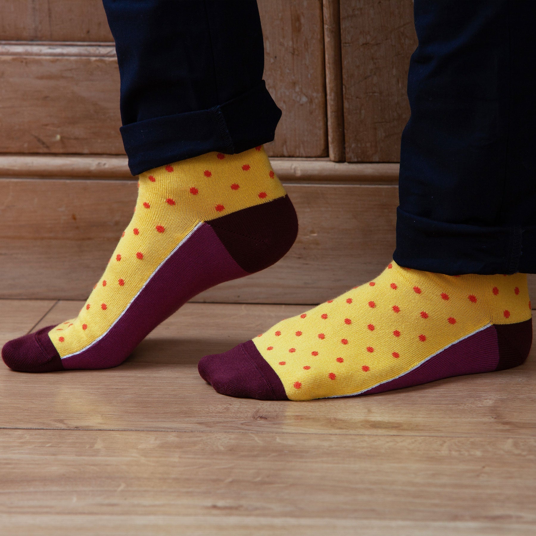 Pin Polka Men's Socks in Honey featuring vibrant polka dots and contrasting cuffs, heels, and toes, made from luxurious Supima cotton.