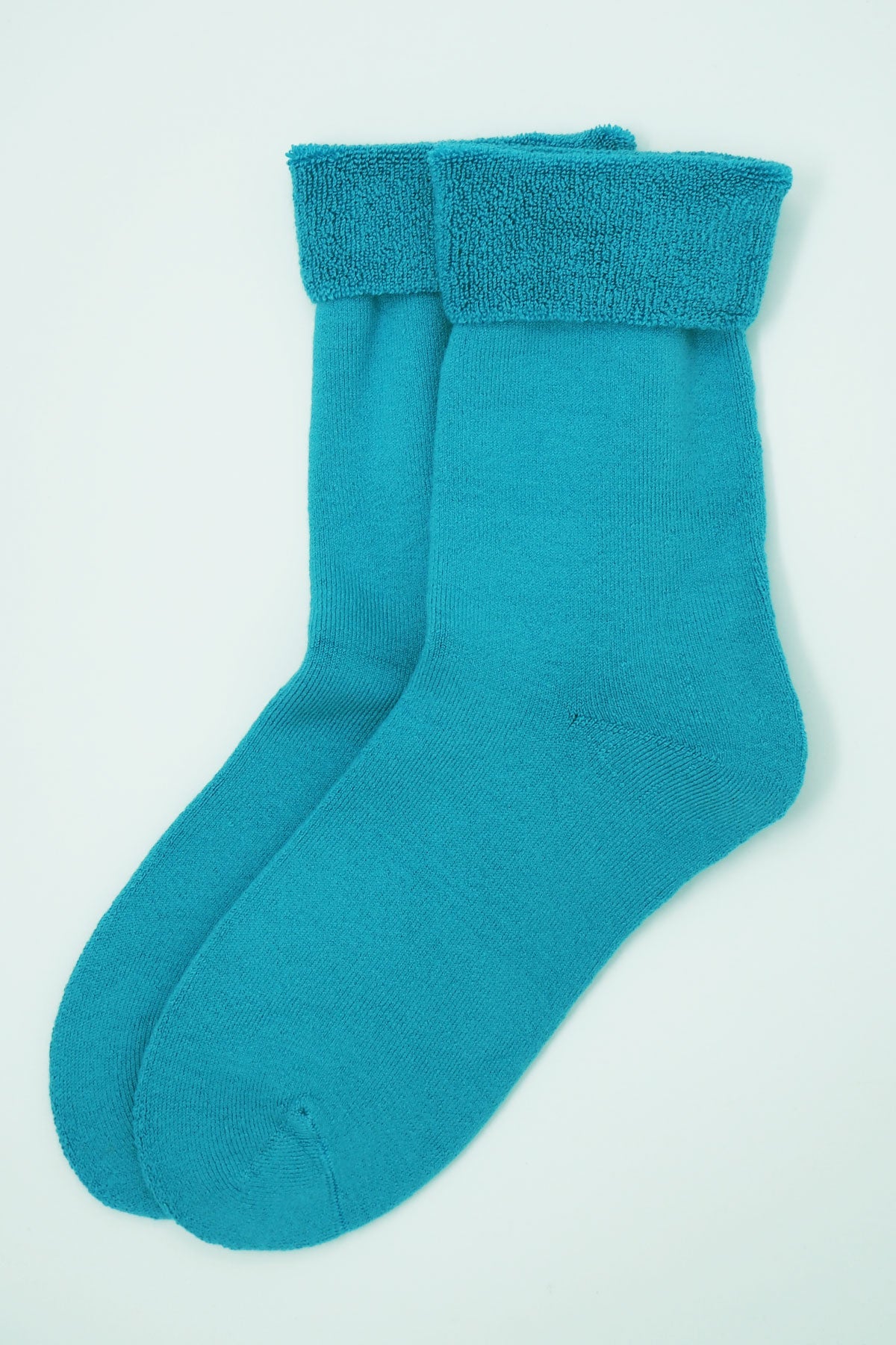 Aqua blue luxury bed socks made from Supima cotton, featuring a fluffy interior and seamless toe design, perfect for men's loungewear.