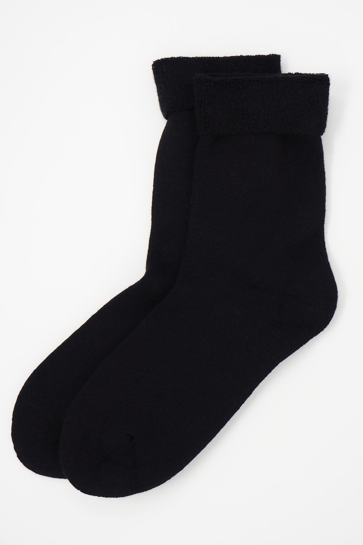 A pair of luxurious black men's bed socks made from soft Supima cotton, showcasing their fluffy interior and seamless toe design.