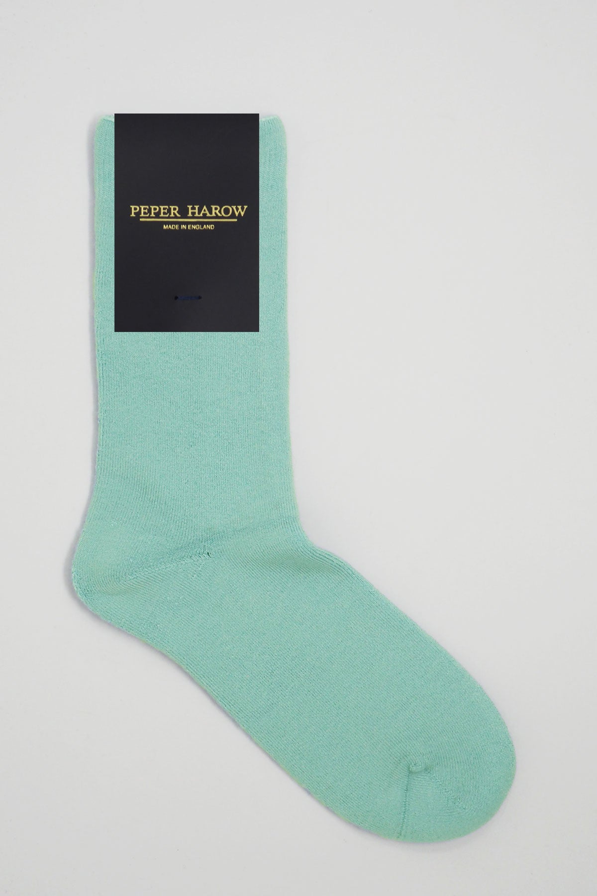 A pair of luxurious light blue men's bed socks made from Supima cotton, showcasing their fluffy interior and seamless toe design.