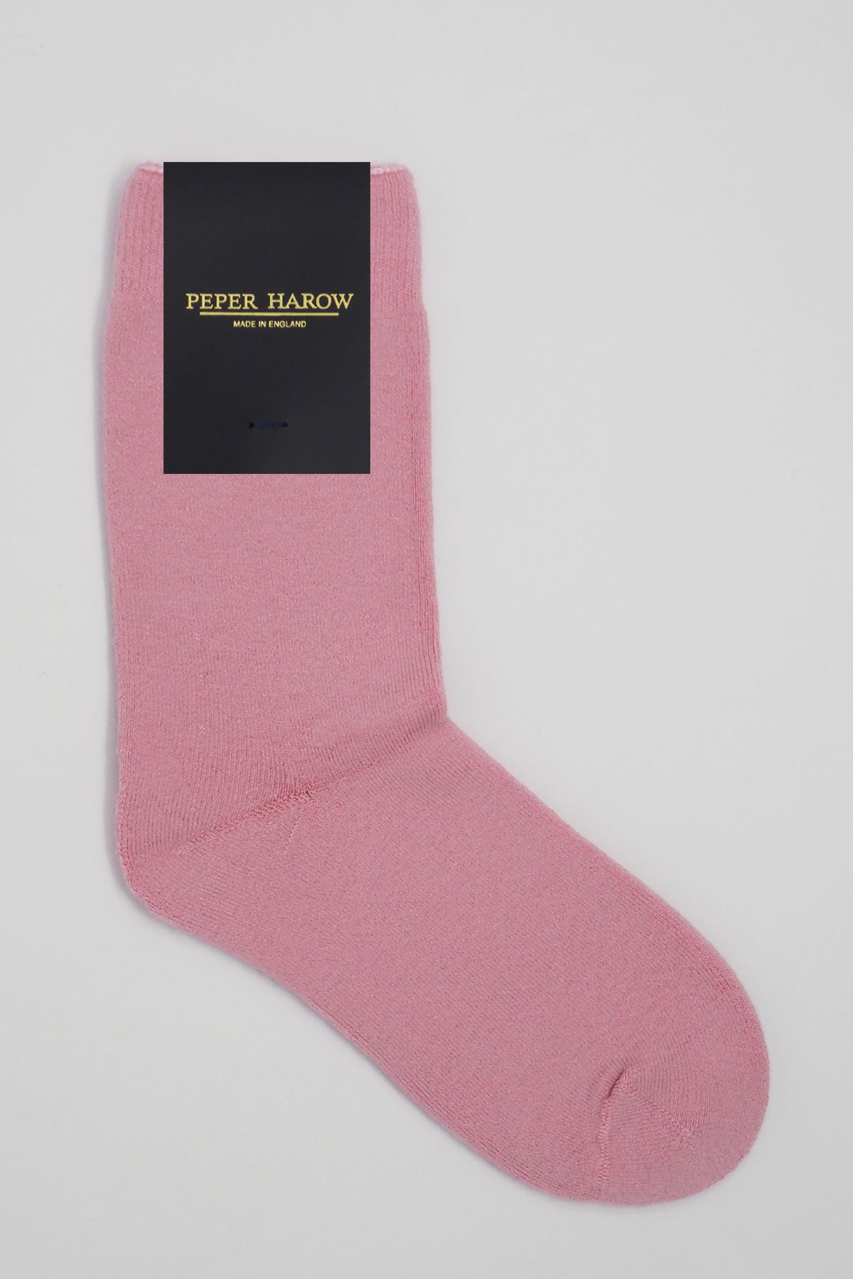 A pair of luxurious pink men's bed socks made from soft Supima cotton, showcasing their fluffy interior and seamless toe design.