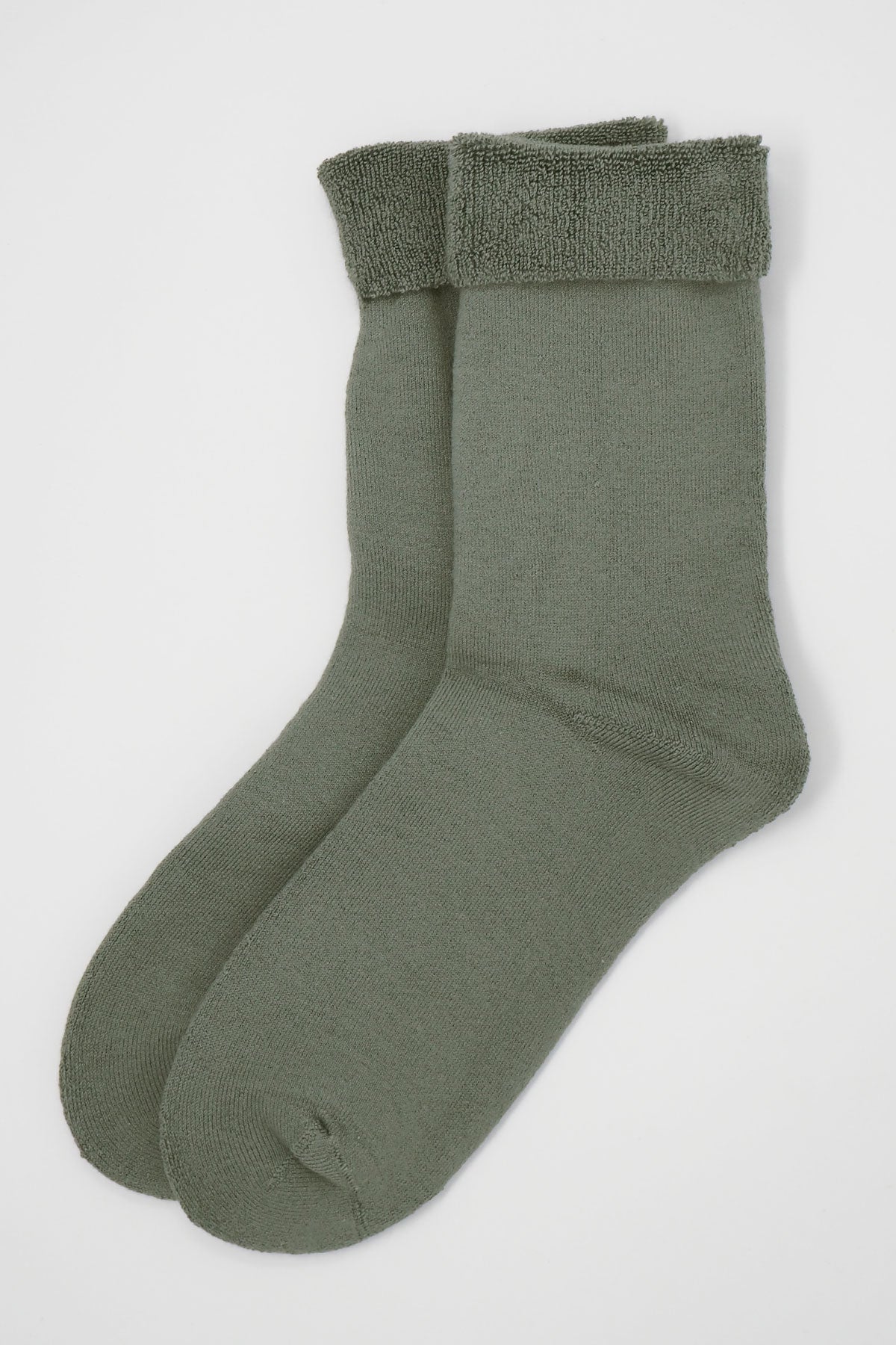 A pair of luxurious grey women's bed socks made from soft Supima cotton, showcasing a fluffy interior and seamless toe design.