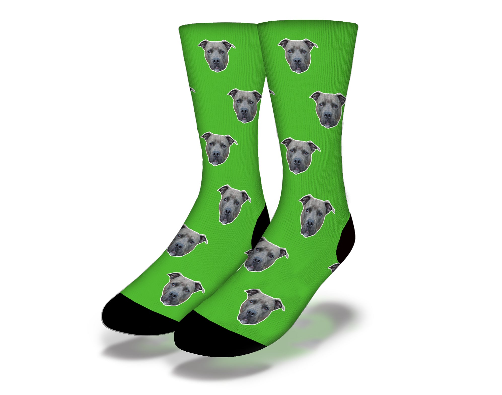 Green socks featuring a cute puppy face with big eyes, perfect for dog lovers.