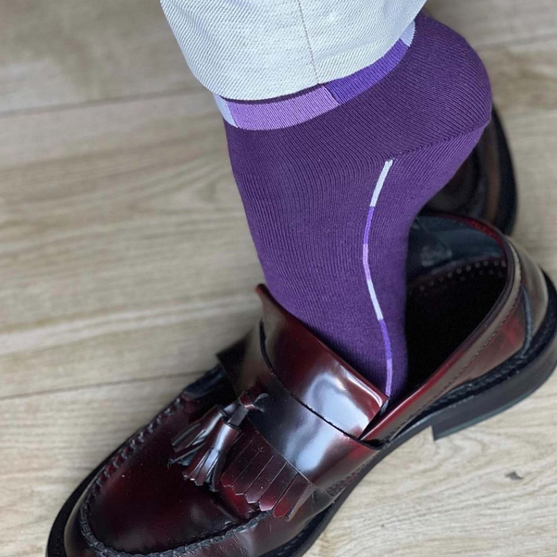 Purple Quad Stripe men's luxury socks made from Supima cotton, featuring vibrant multi-hued stripes and a seamless toe design.