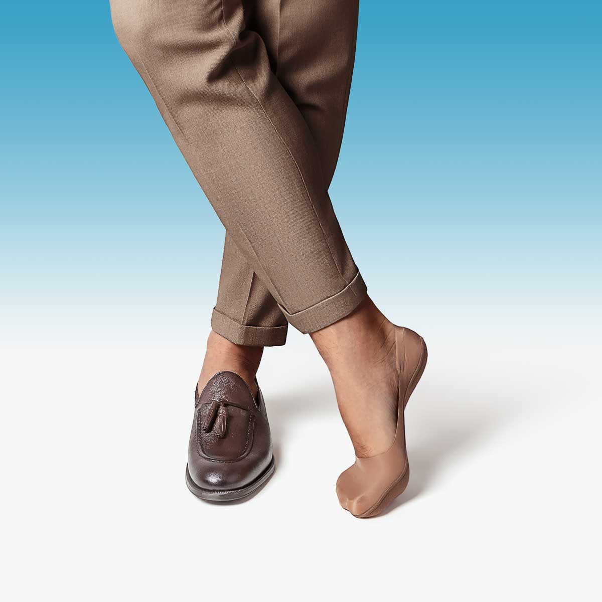 A pair of tan mid-cut ultra-thin no show socks designed for discreet wear with dress shoes.