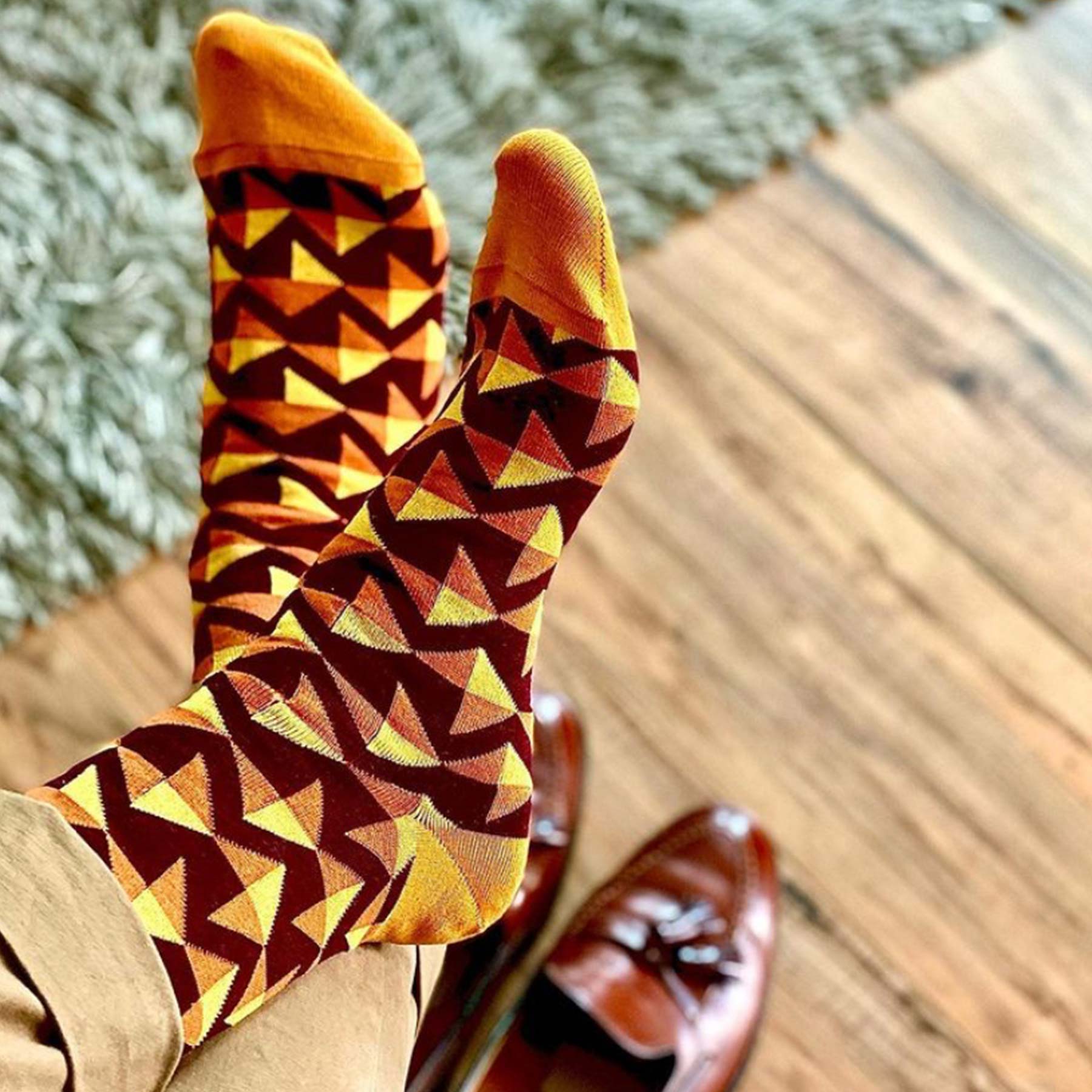 Triangle Men's Socks in maroon featuring vibrant orange and yellow triangles, showcasing a unique and stylish design.