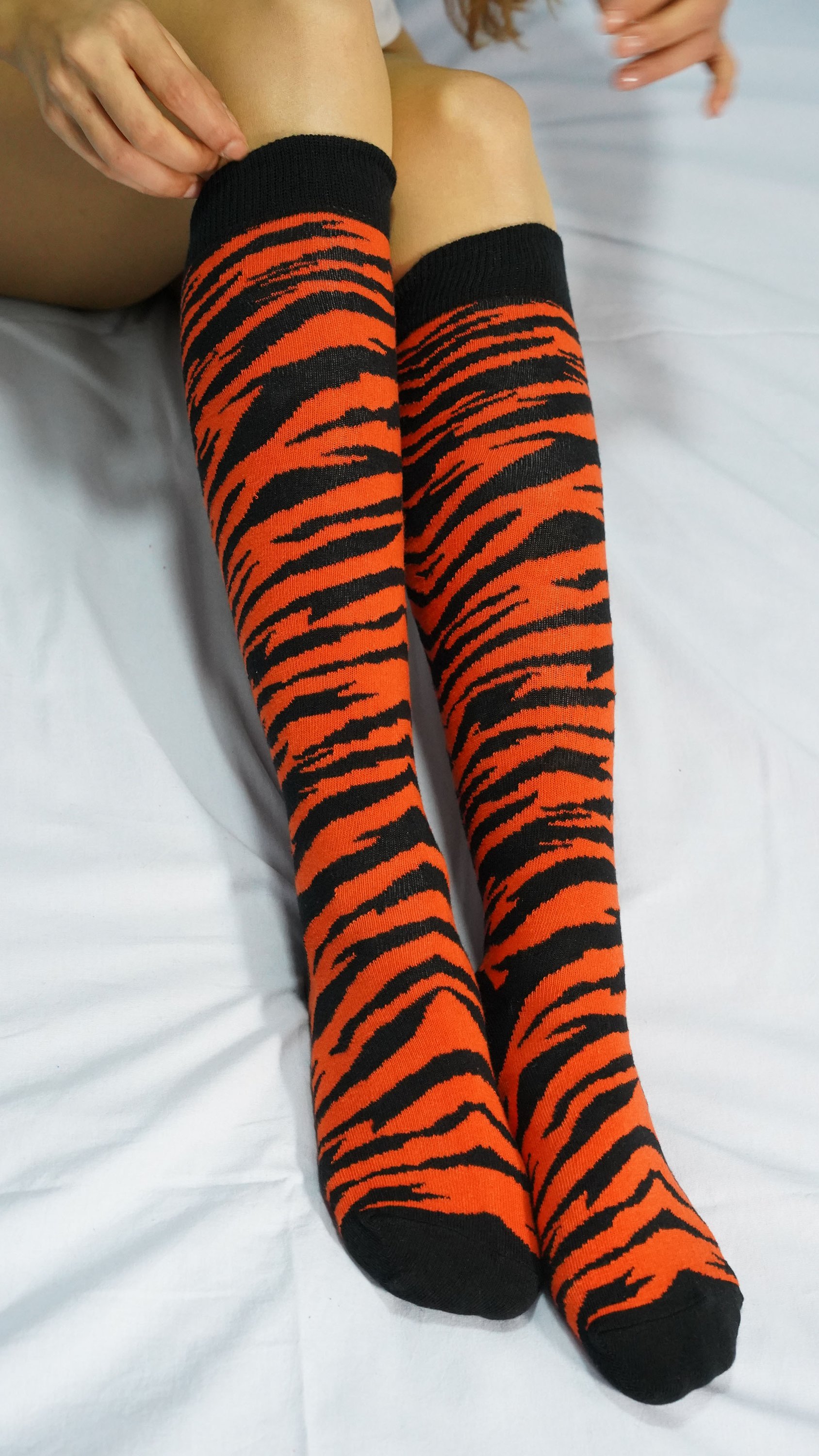 A vibrant set of Women's Animal Kingdom Knee High Socks featuring colorful animal patterns, perfect for adding a fun touch to any outfit.