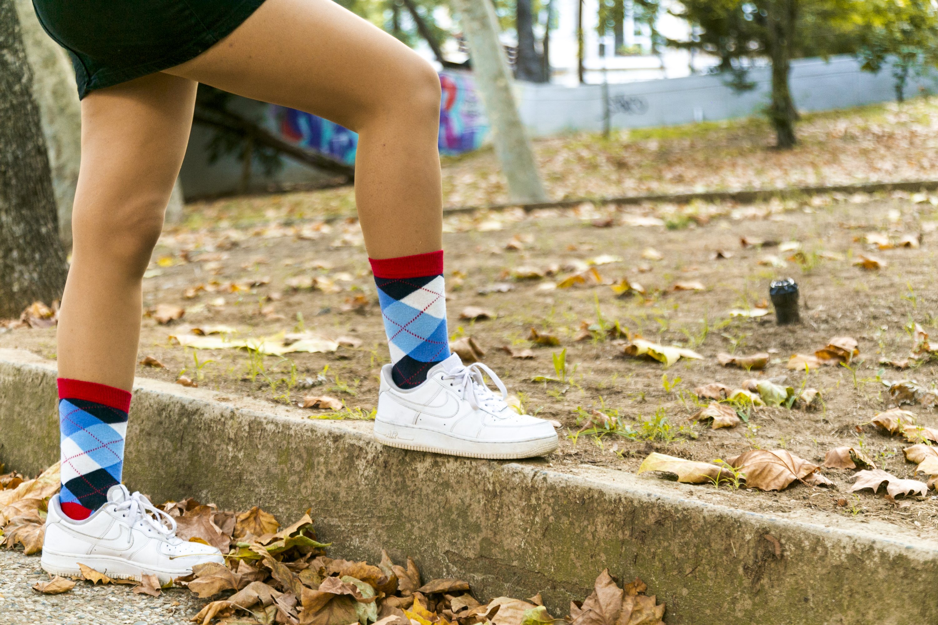 A pair of Women's Cerulean Red Argyle Socks featuring a vibrant pattern, made from soft Turkish cotton for comfort and style.