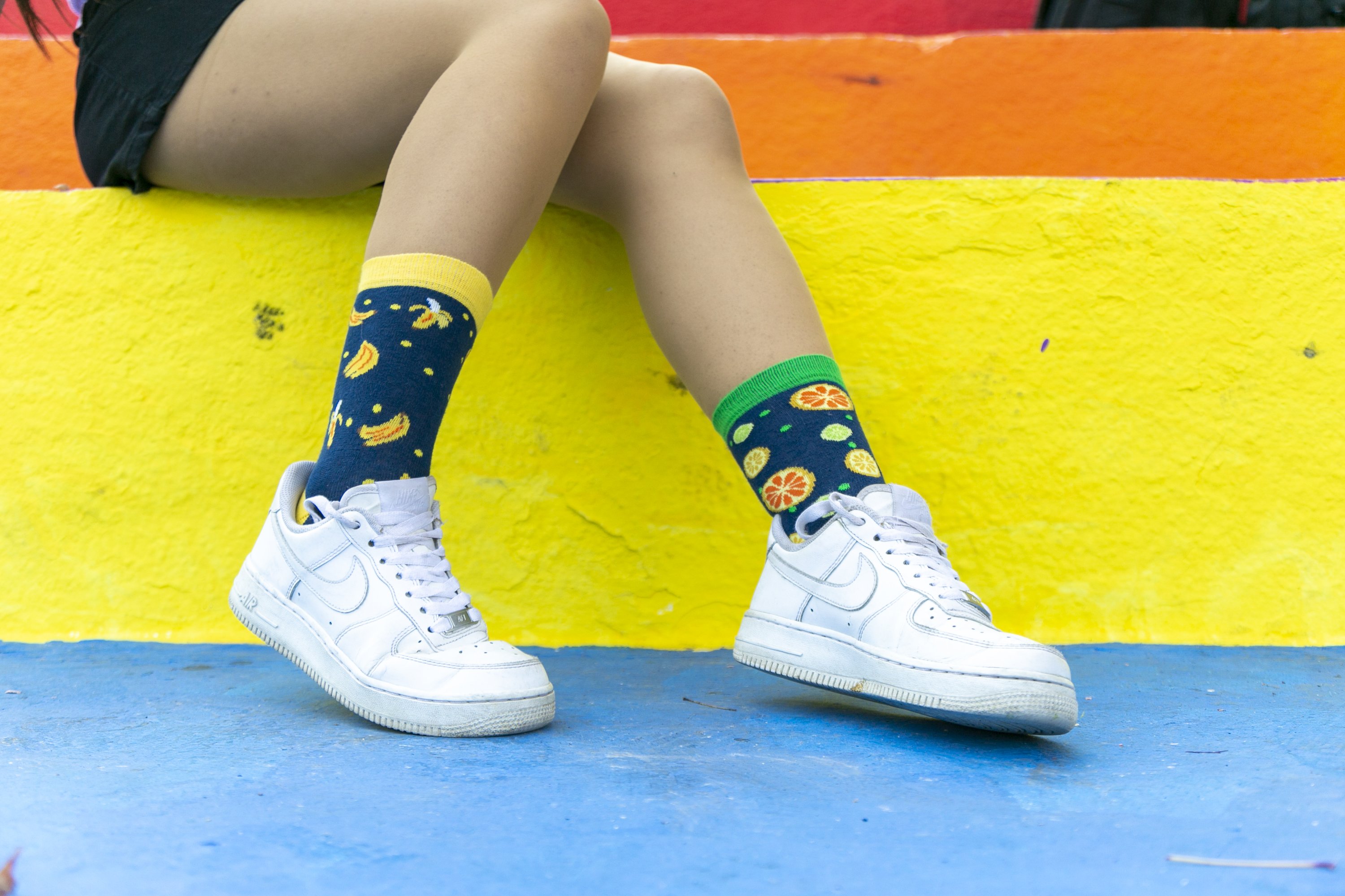 A vibrant set of Women's Cheerful Fruits Socks featuring colorful fruit patterns, perfect for adding fun to any outfit.