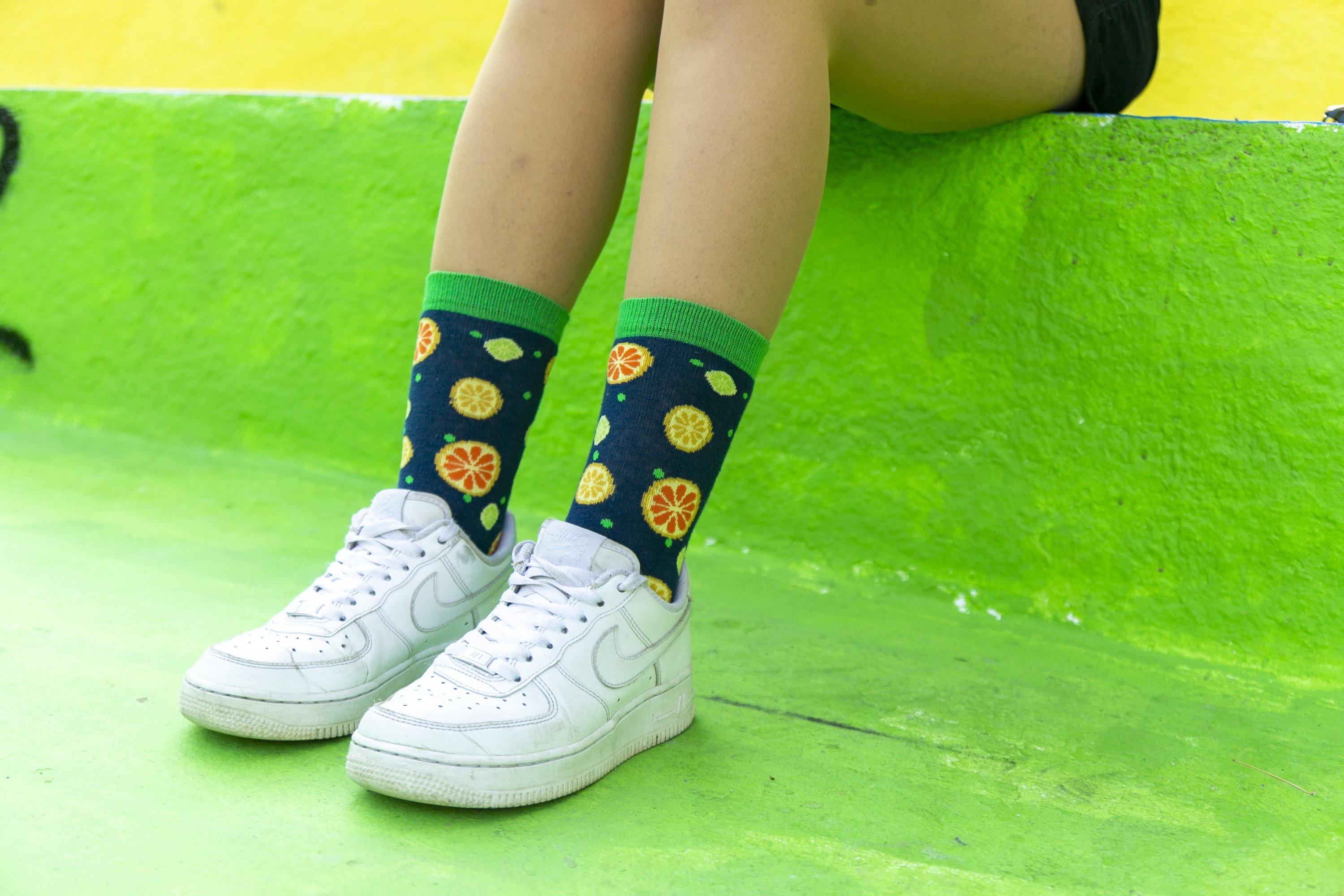 A vibrant set of Women's Cheerful Fruits Socks featuring colorful fruit patterns, perfect for adding fun to any outfit.